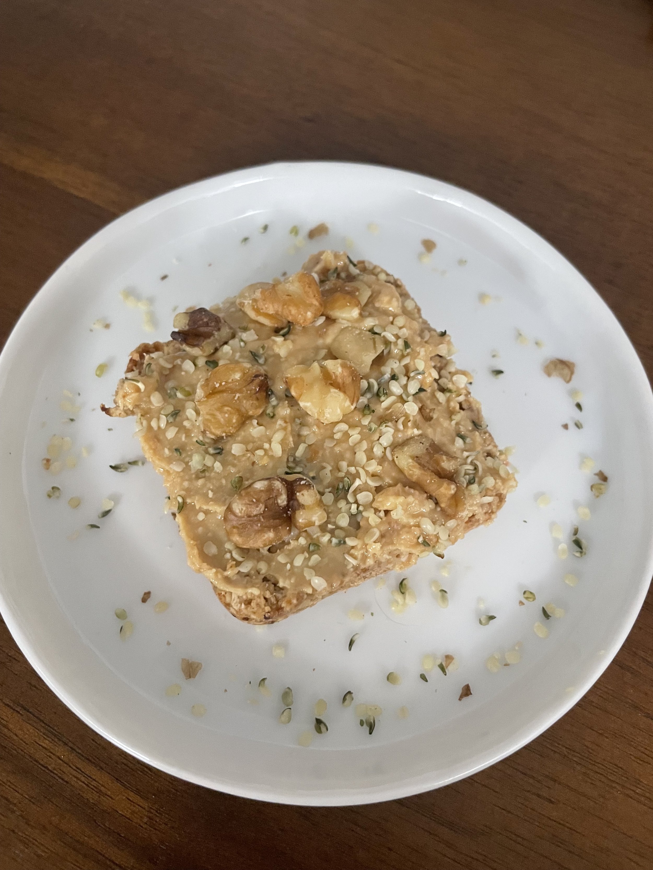 Topped with nut butter and extra nuts and seeds for a snack