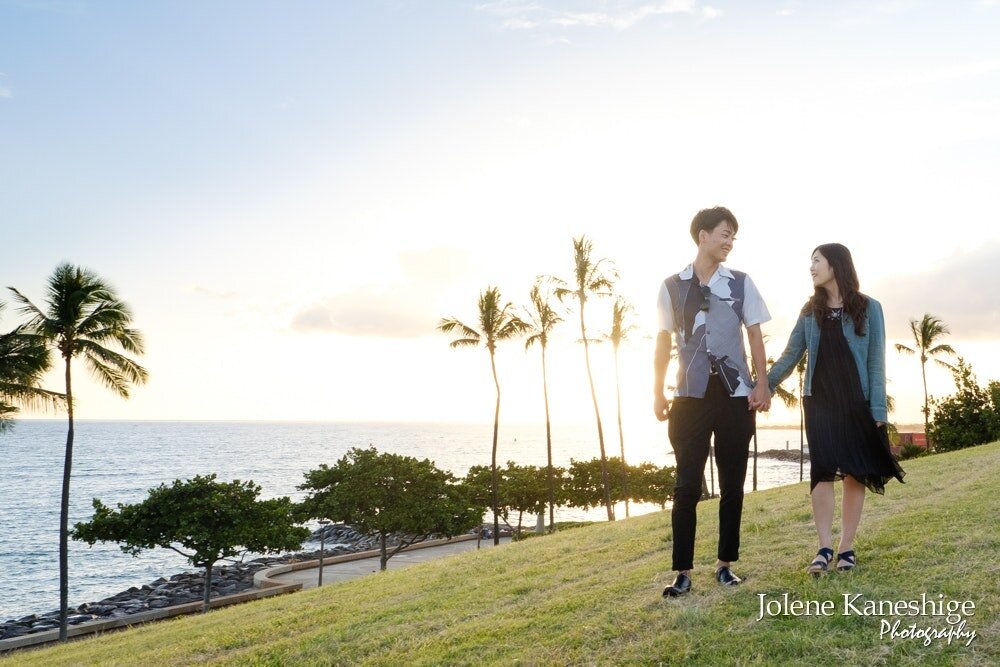 Experience the magic of a sunset proposal in Hawaii!  As the sun dips below the horizon, the sky is painted in vibrant hues of orange, pink, and purple, creating a breathtaking backdrop for a romantic evening. Take a leisurely stroll along the coast,