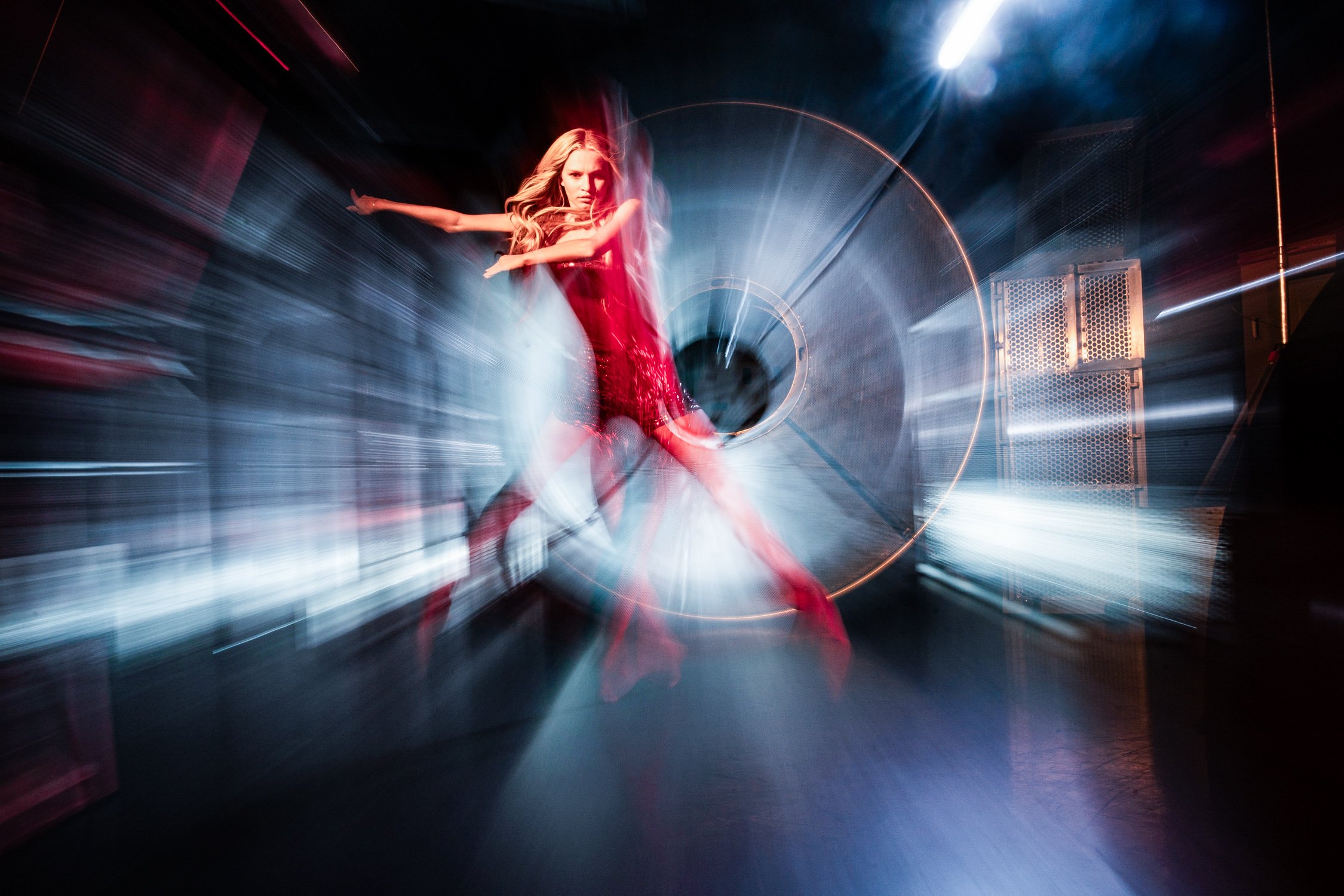 Dancer in red jumping with background blurred with zoom