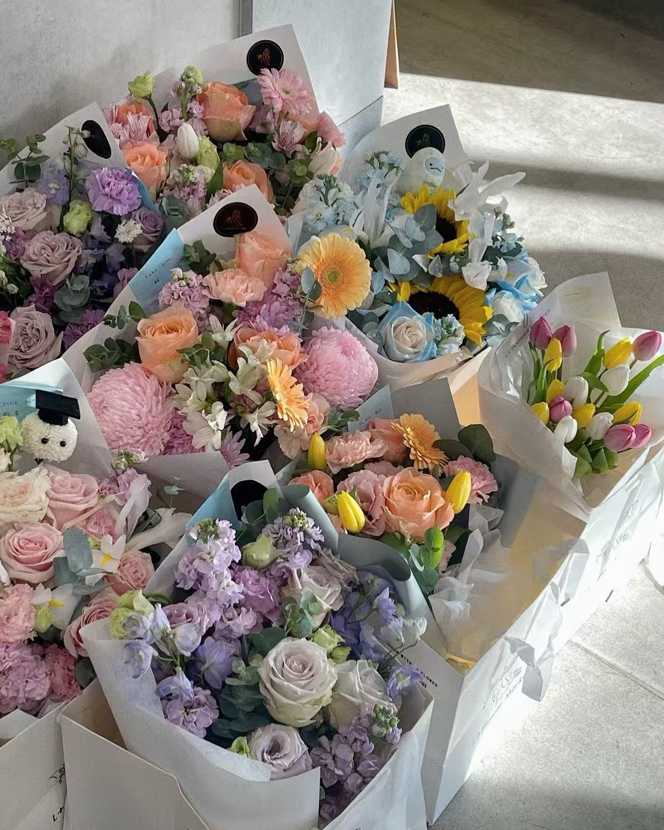 Morning light &amp; moments waiting to bloom.
The shop is quiet, but the flowers speak.
Some are headed to mothers &mdash;
for love, for gratitude, for all that can&rsquo;t be said in words.
Others, to graduates &mdash;
for growth, for pride, for new