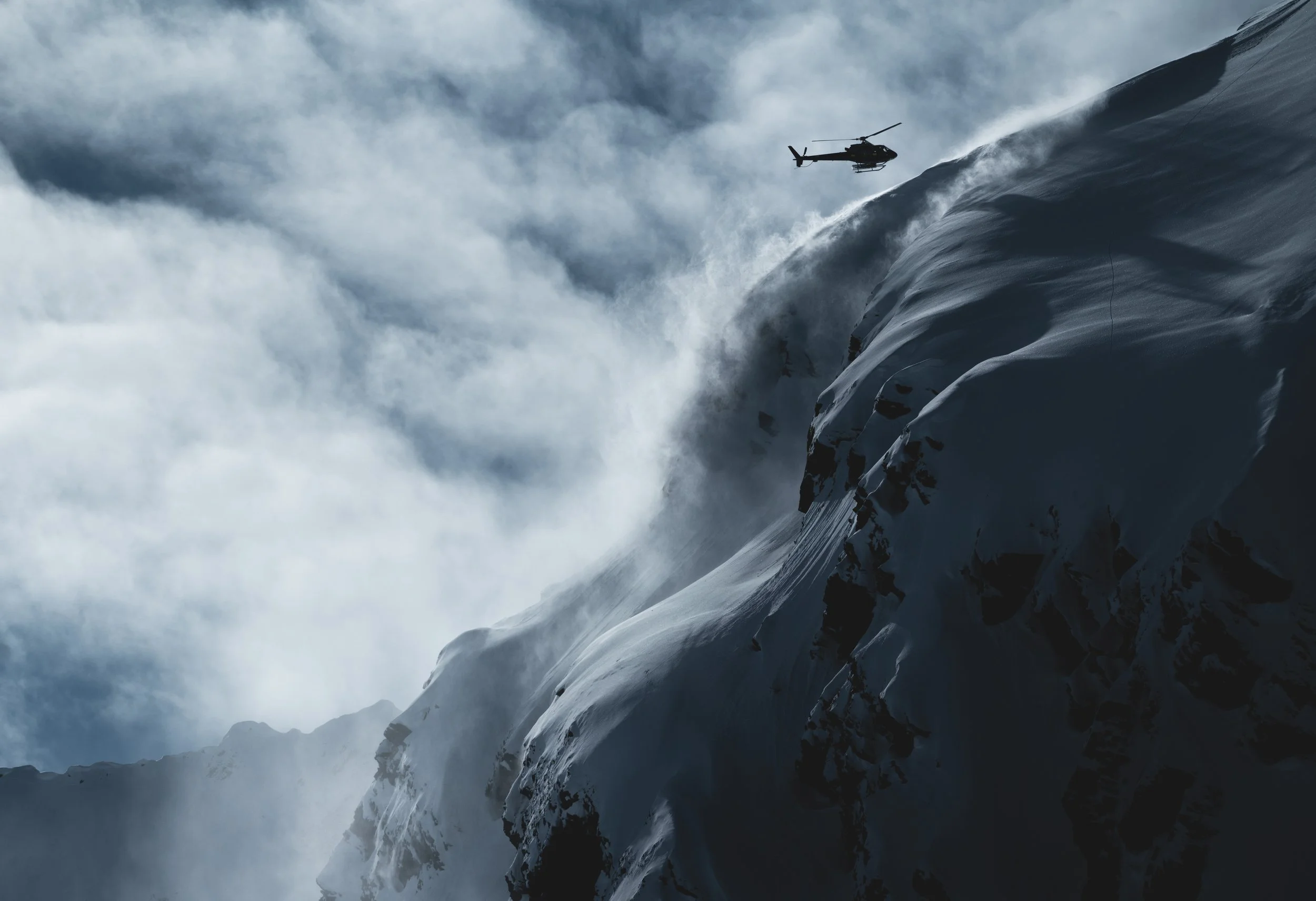 helicopter hovering on side of mountain.jpg