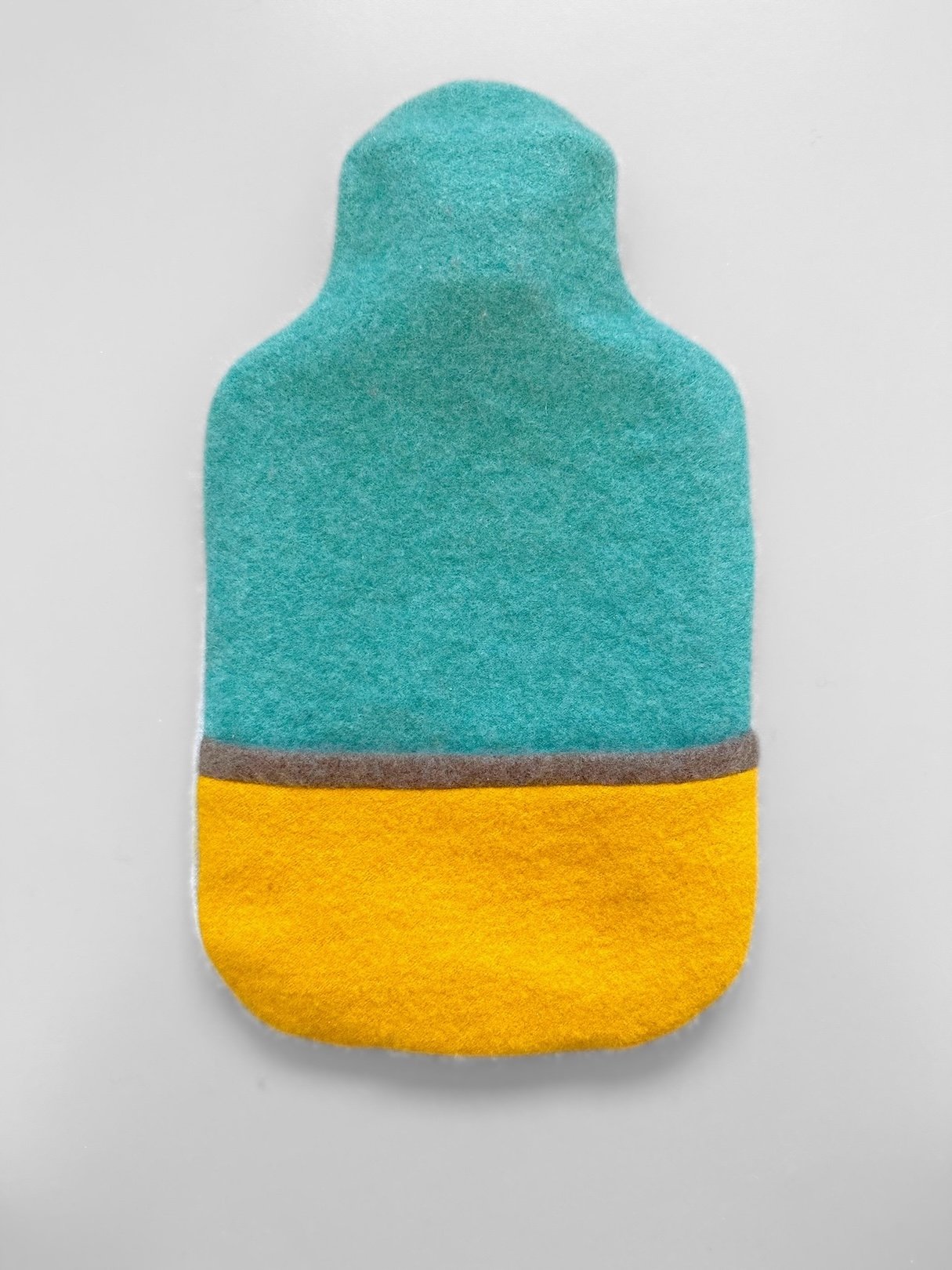 Cashmere hot water bottle in sunshine yellow and light teal.