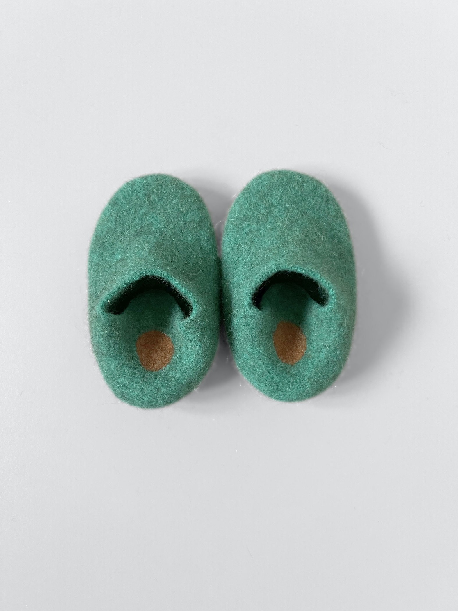 Repurposed children's wool slipper with a soft leather sole.