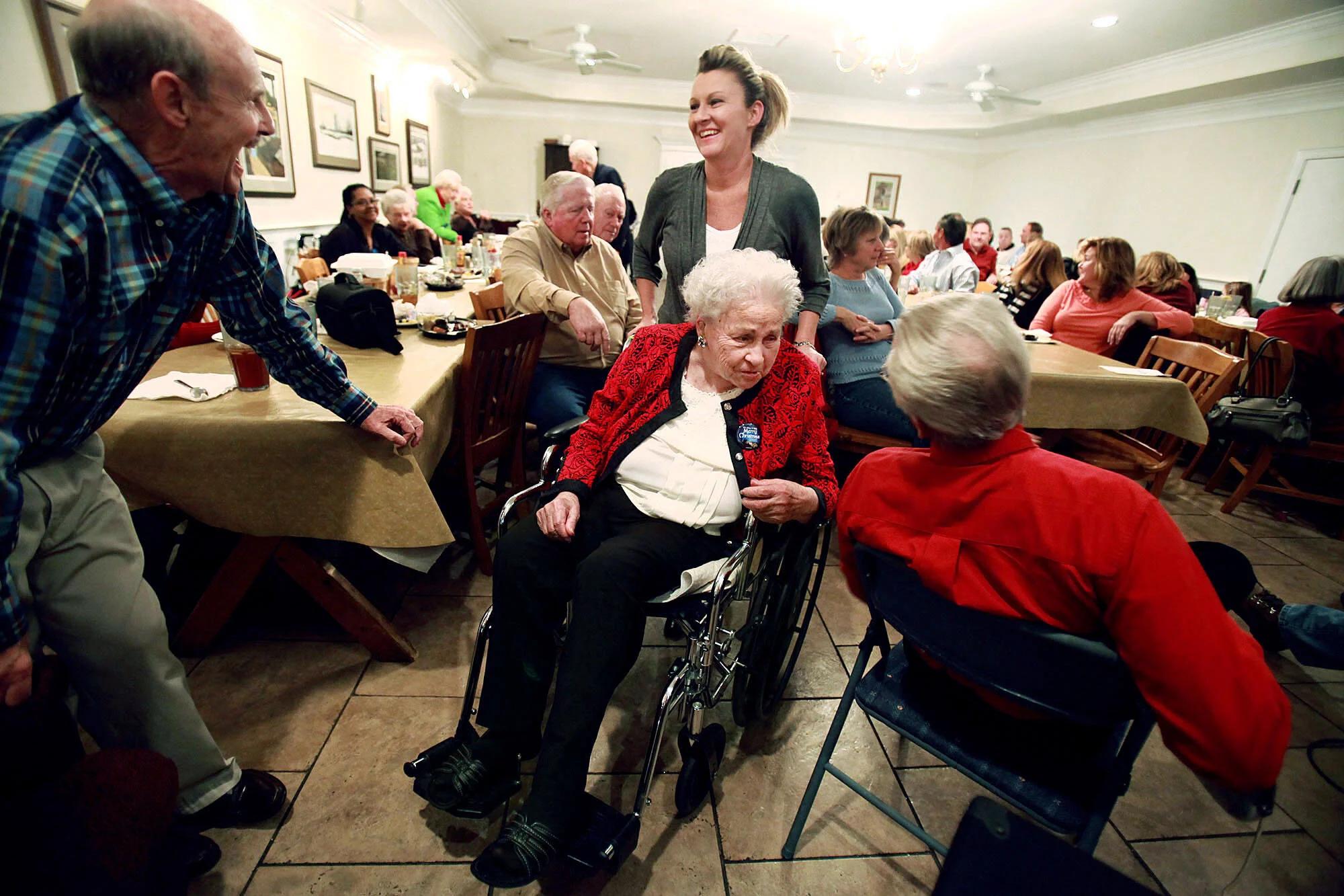  Elizabeth greets bass player Raymond as her son-in-law, Mike, and granddaughter, Francie, talk during a Christmas party with Elizabeth's family and close friends.  Danny organized the party for Elizabeth so she could listen to his band play and spen