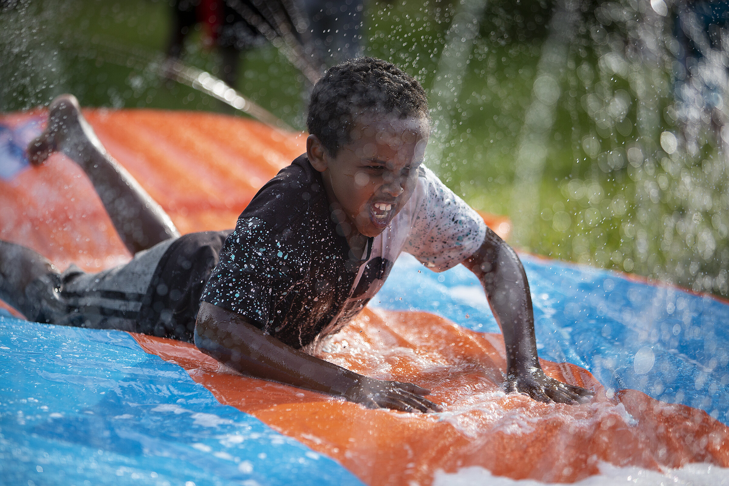  Abdinasir Mohamed goes down a water slide. 
