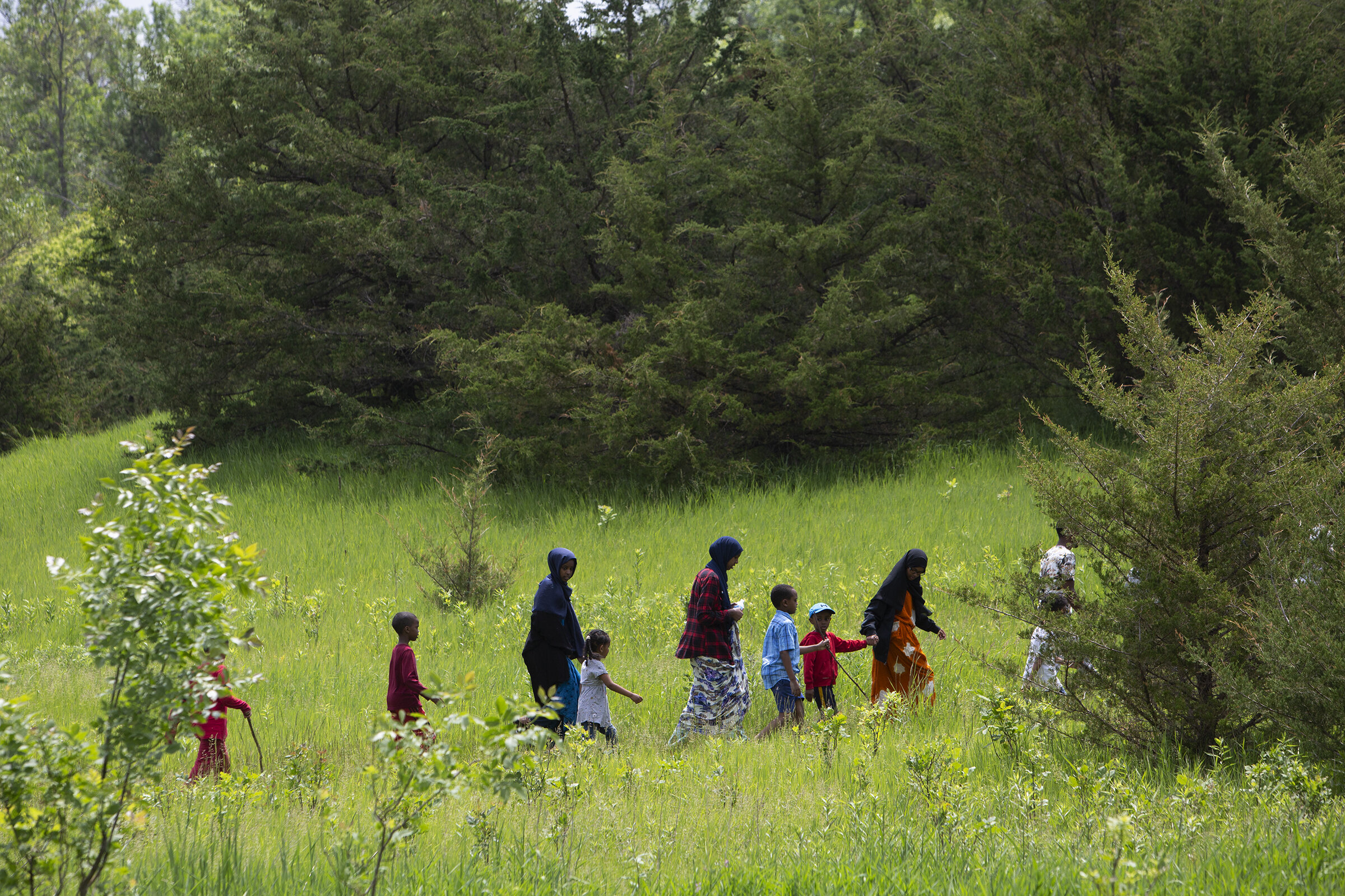  Campers hike on one of the trails toward the horse camp at Sibley State Park. Outdoor recreation can fall outside the norm for immigrant parents, which is why they’re invited along to experience camp along with the kids. 