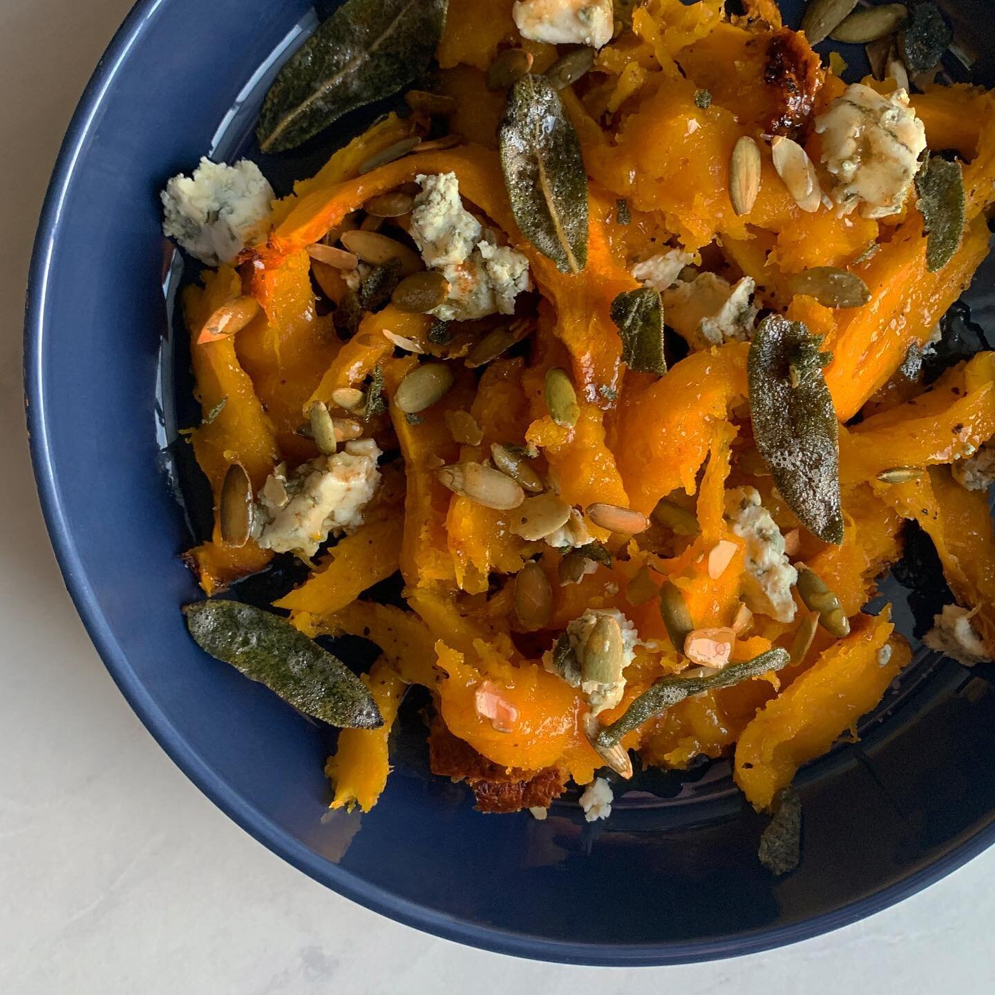 I had this sugar pumpkin sitting around on my sideboard looking pretty nice at Thanksgiving but today I was finally like &ldquo;Thanksgiving is over!&rdquo; so then I roasted it and made this:

Shredded roasted pumpkin flesh with Gorgonzola and pepit