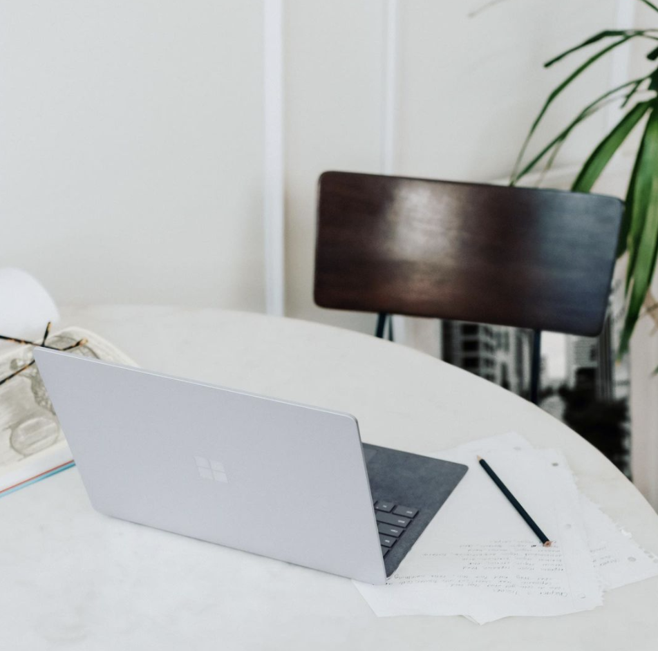 Bright natural dining room nook with vases plates and fruits on the table.
