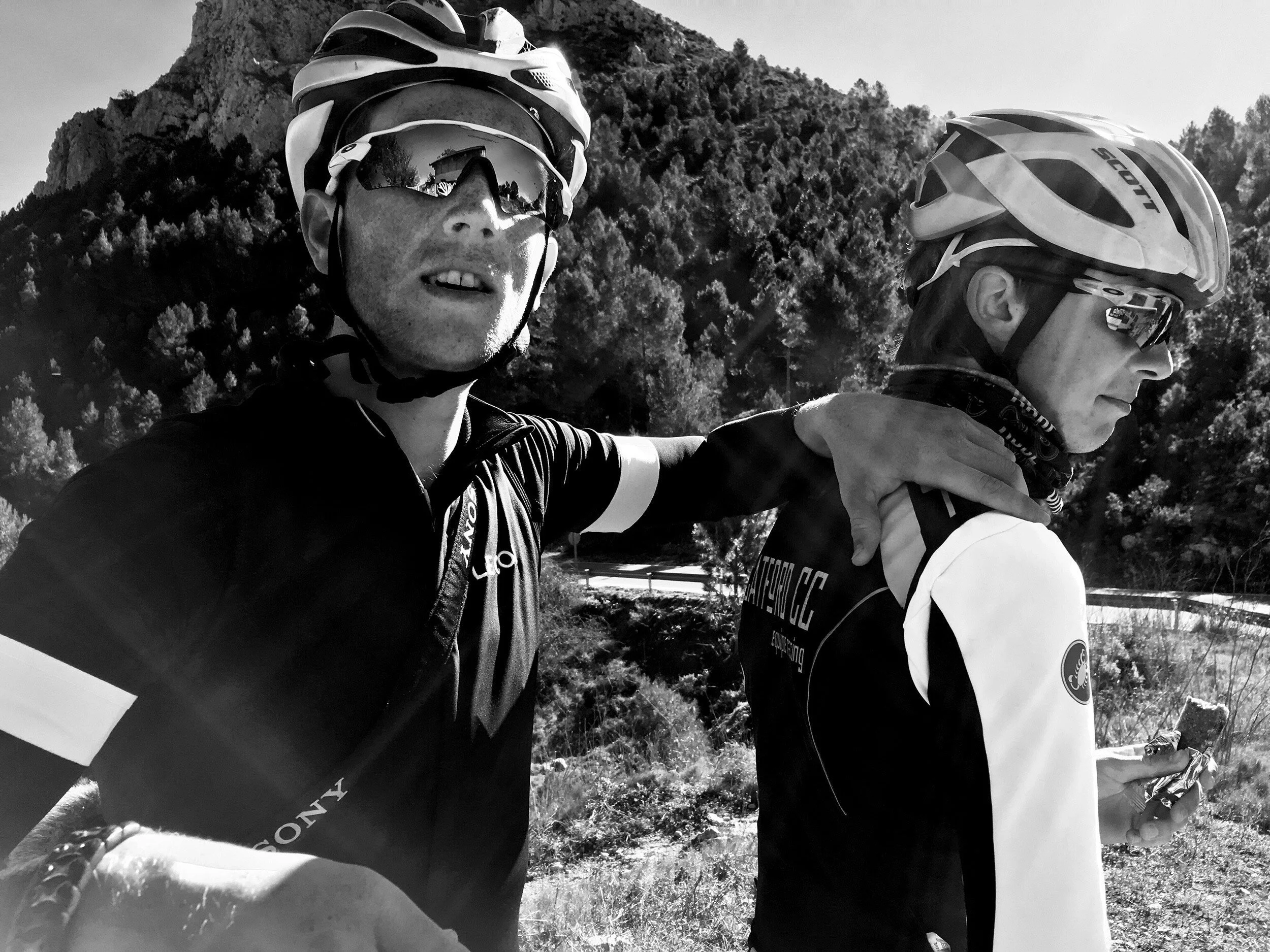 two+cyclists+embracing+each+other+at+the+top+of+a+mountain+by+Nathaniel+Rosa.jpg