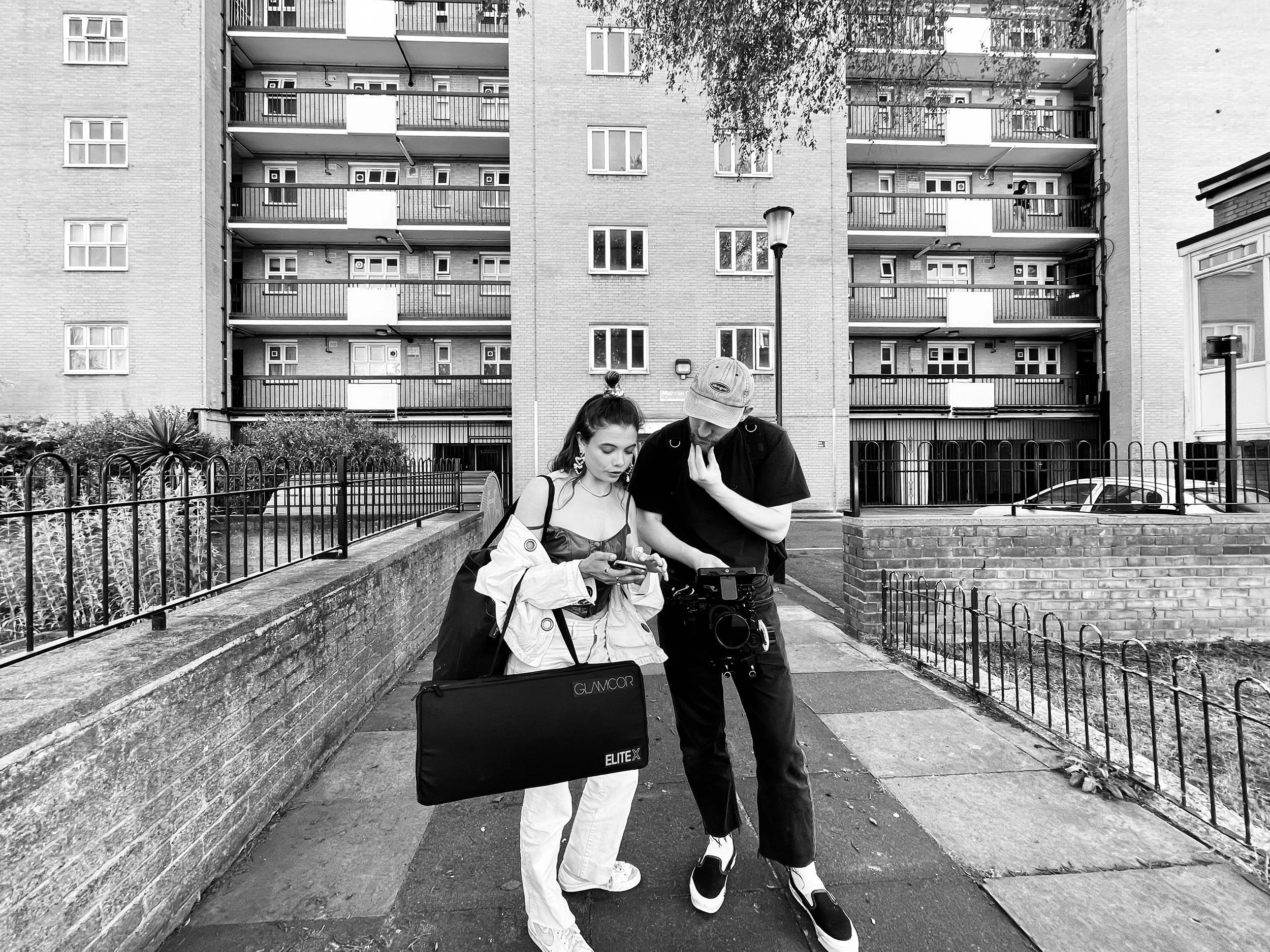 Male+and+female+looking+at+mobile+phone+in+london+housing+estate+by+Nathaniel+Rosa+shot+on+iphone.jpg