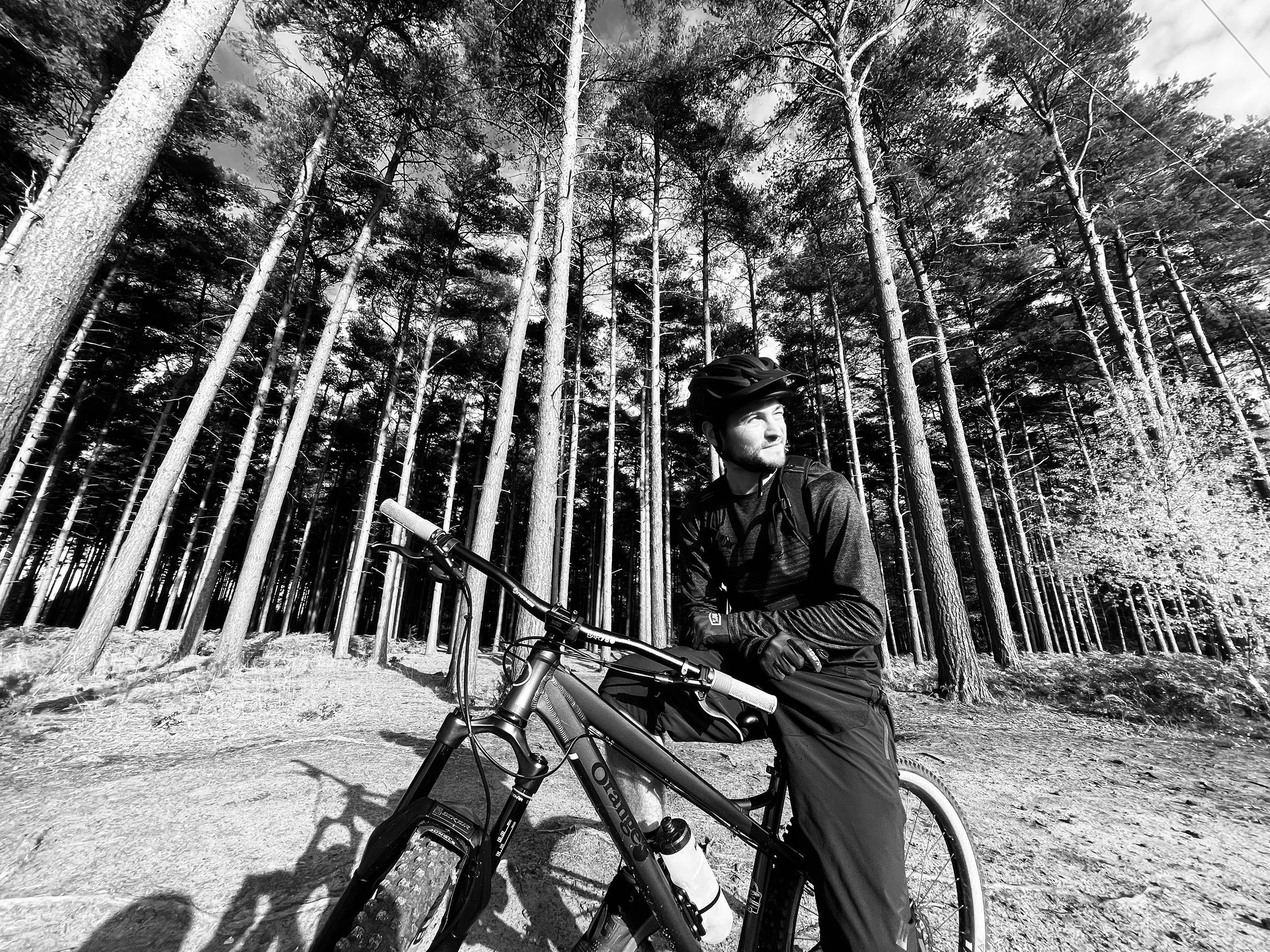 mountain+biker+in+front+of+tall+woods+by+Nathaniel+Rosa+shot+on+iphone.jpg