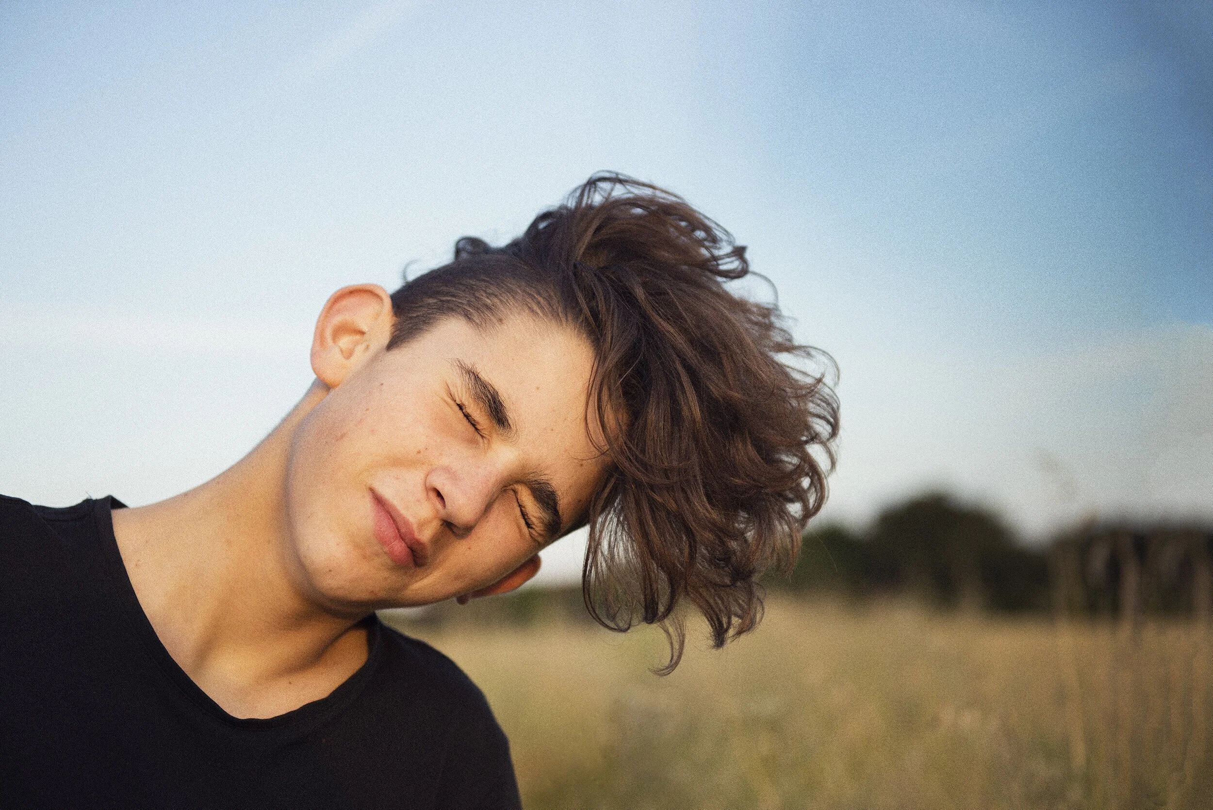 Teenage+boy+with+long+hair+hanging+out+in+a+field+by+nathaniel+rosa.jpg
