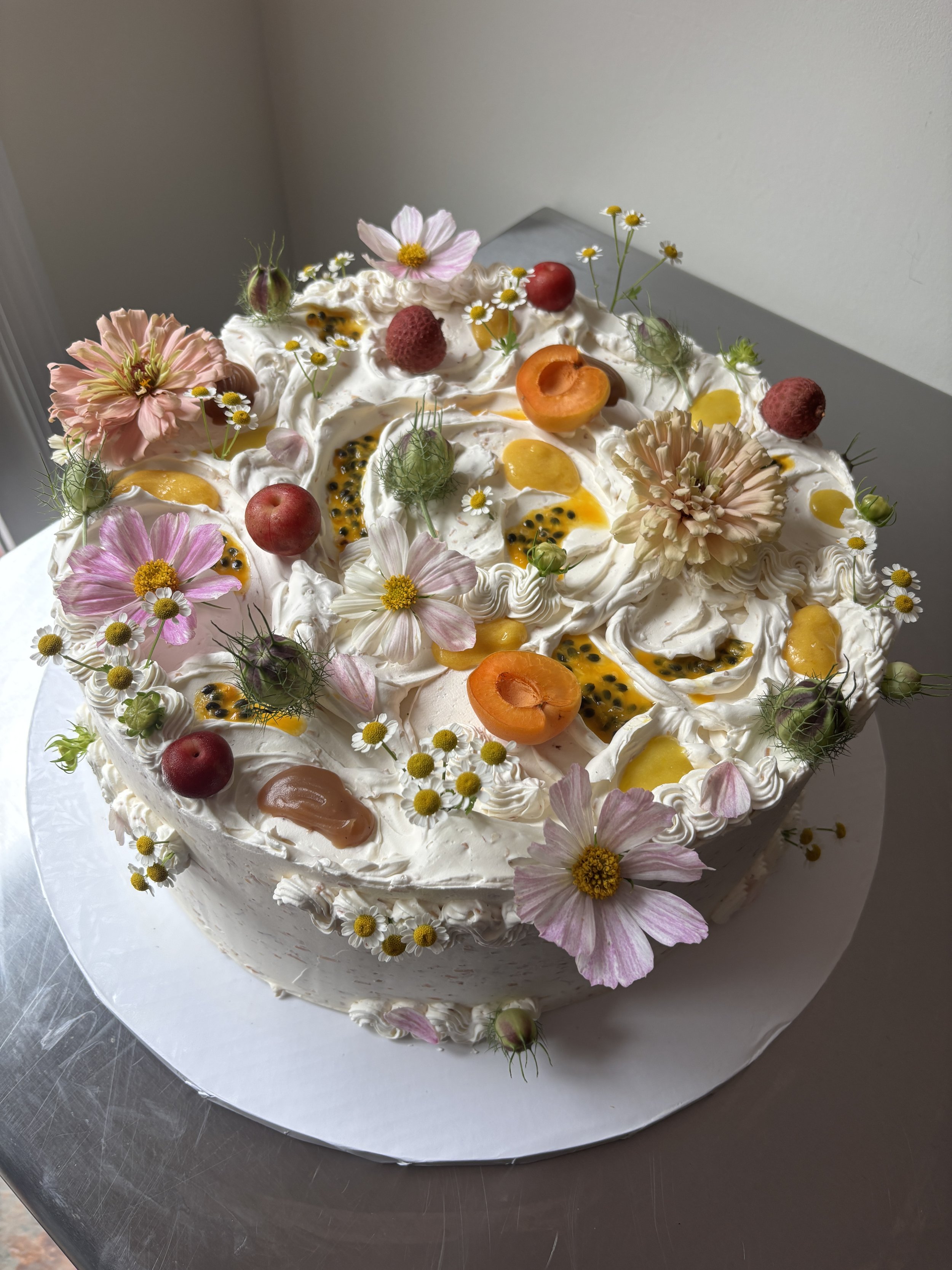 M & U 
passion fruit cake / passion fruit curd / persian lime curd / tahini caramel / toasted coconut swiss meringue buttercream (14 inch round)