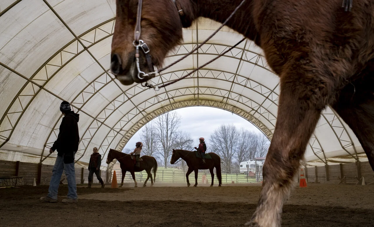 Amy Whaley, left, and Heidi, teach riding to Kenna and Gwyn Sayre in Shade, Ohio. Heidi installed this riding enclosure because she wanted a better way to ride year round and to teach inside of.