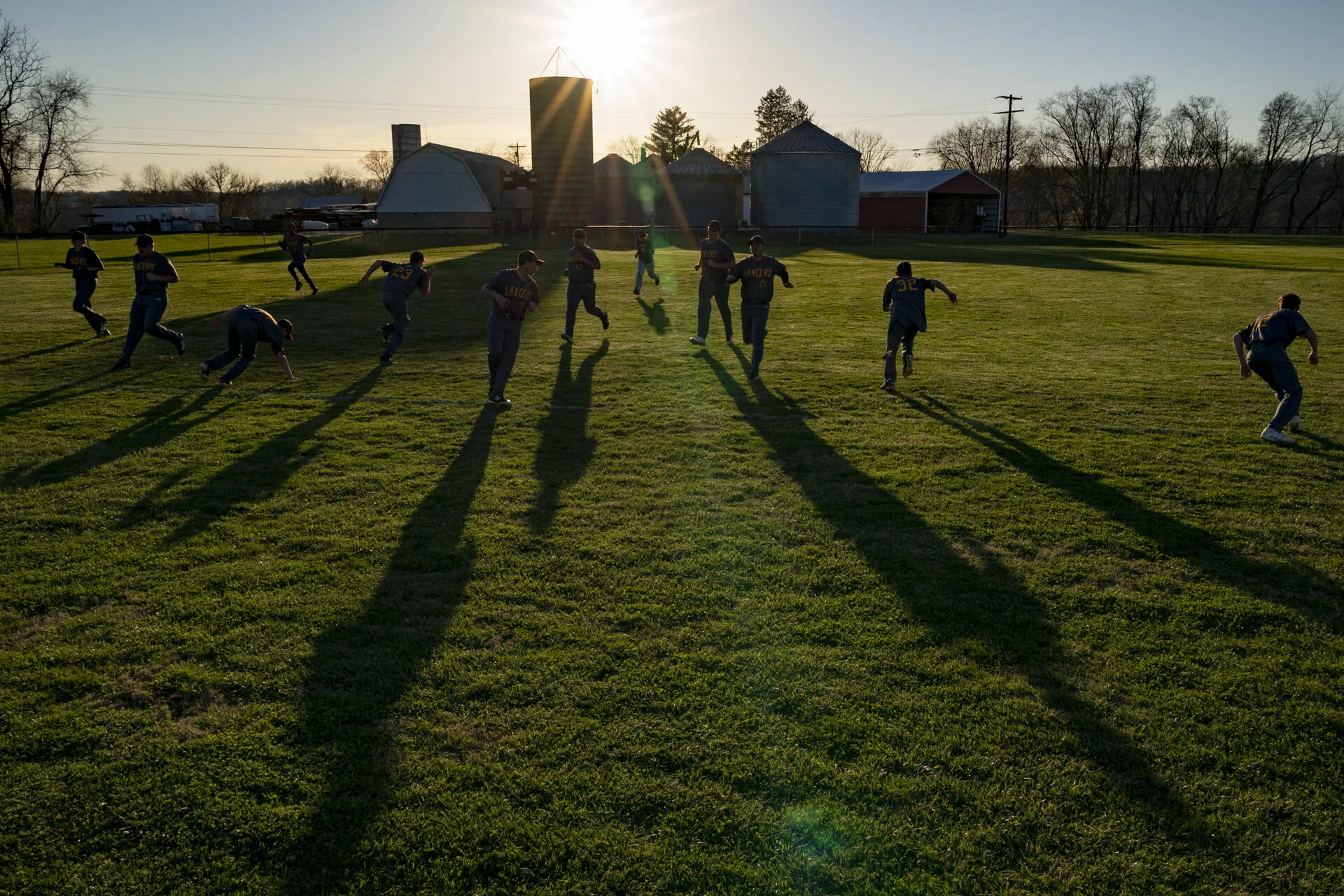  The Federal Hocking Lancers boys varsity baseball team exercises in a post-game run in Stewart, Ohio, after winning their game against Miller High School 14-1. Given the size of the school and number of students enrolled in athletics, occasionally d