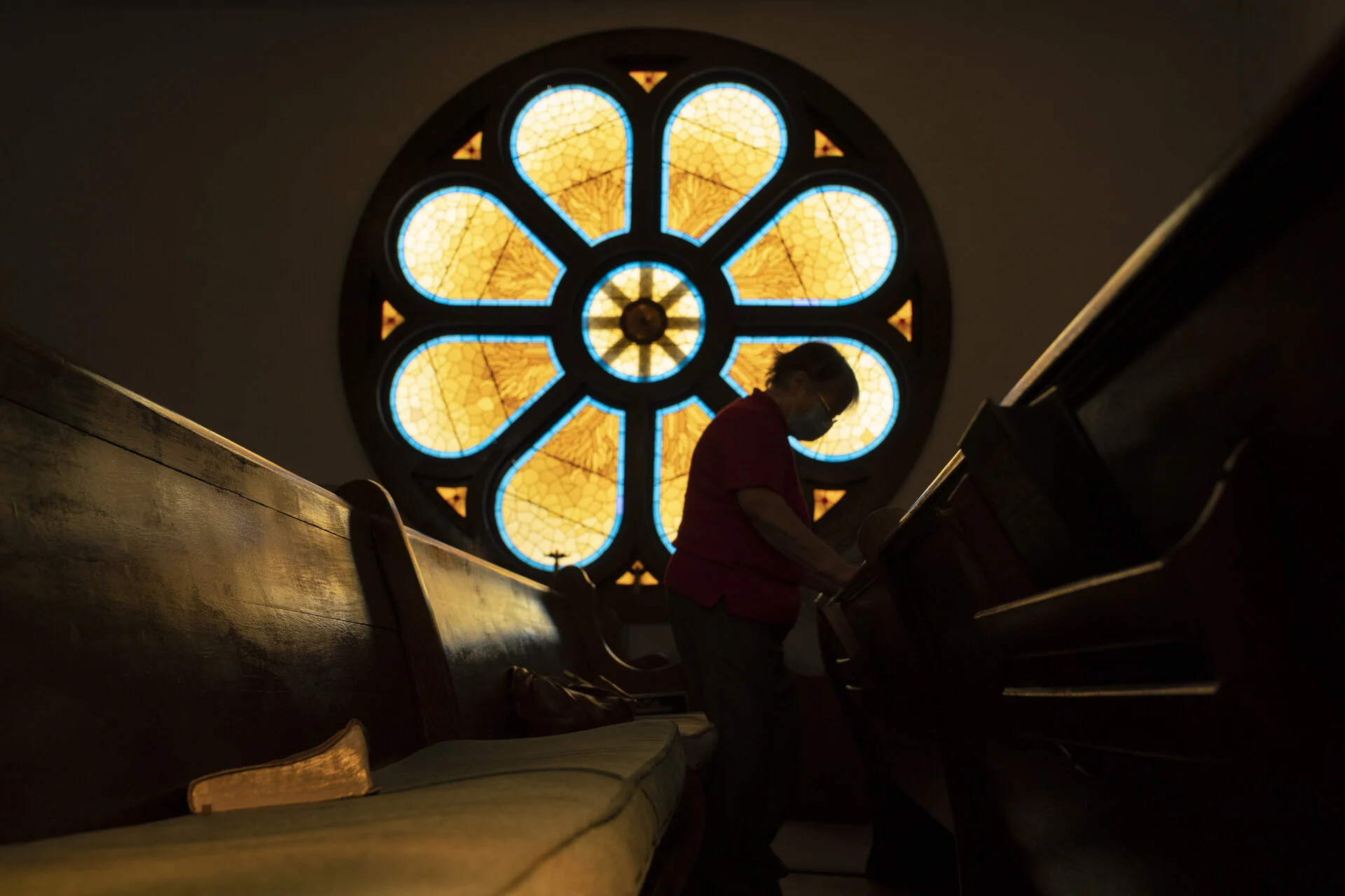  Myrtle Gabrielle prays inside of the Stewart United Methodist Church in Stewart, Ohio. The circular stained glass window was originally built for a church in Washington D.C.. However, that church was torn down, and the window salvaged and saved. In 