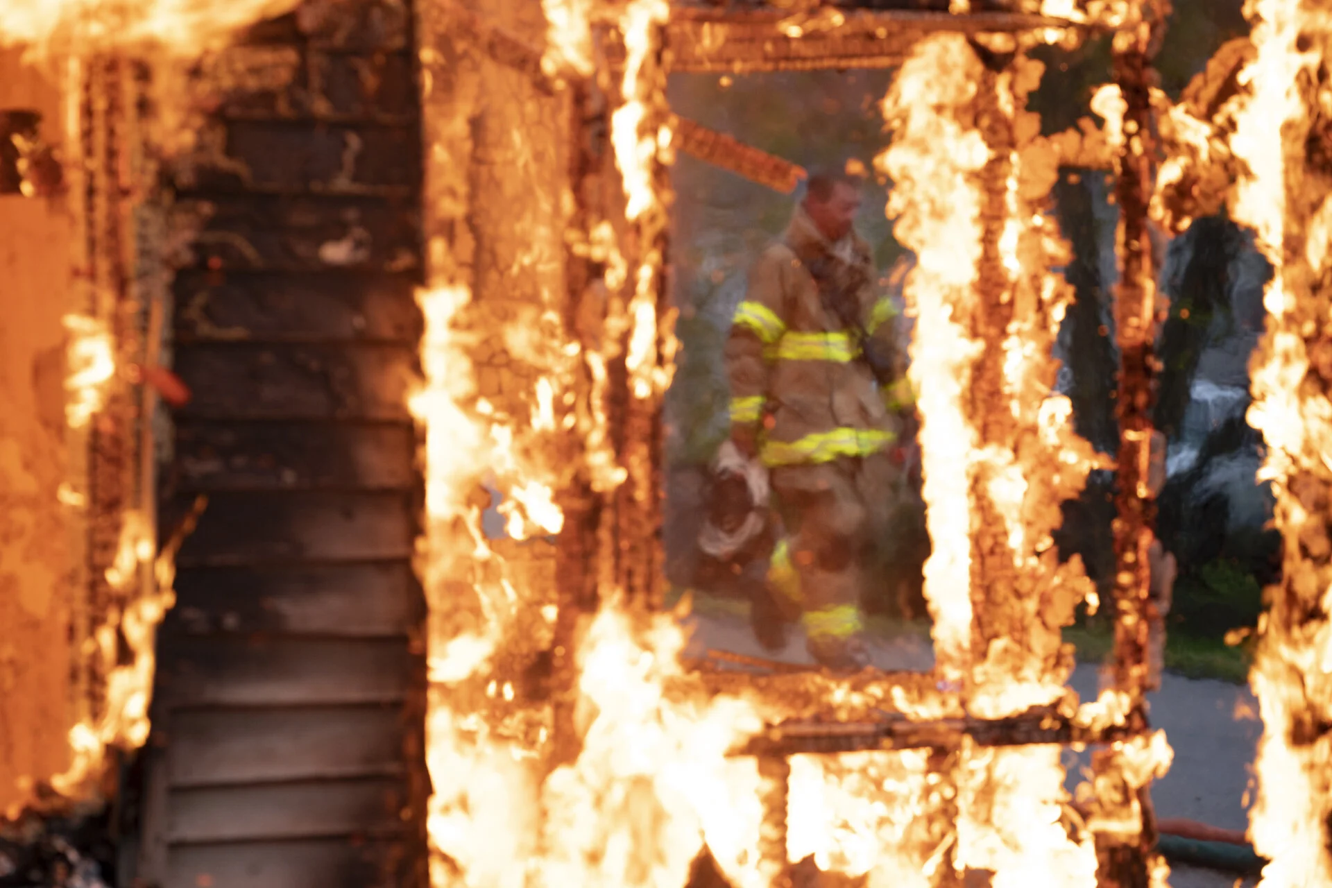  Fire Chief Mike Hart is seen through the flames of a building the Rome Twp. Volunteer Fire Department is burning for training, in Stewart, Ohio. For years, Mike has lived life with varying degrees of kidney failure. However, on September 10, 2020, h