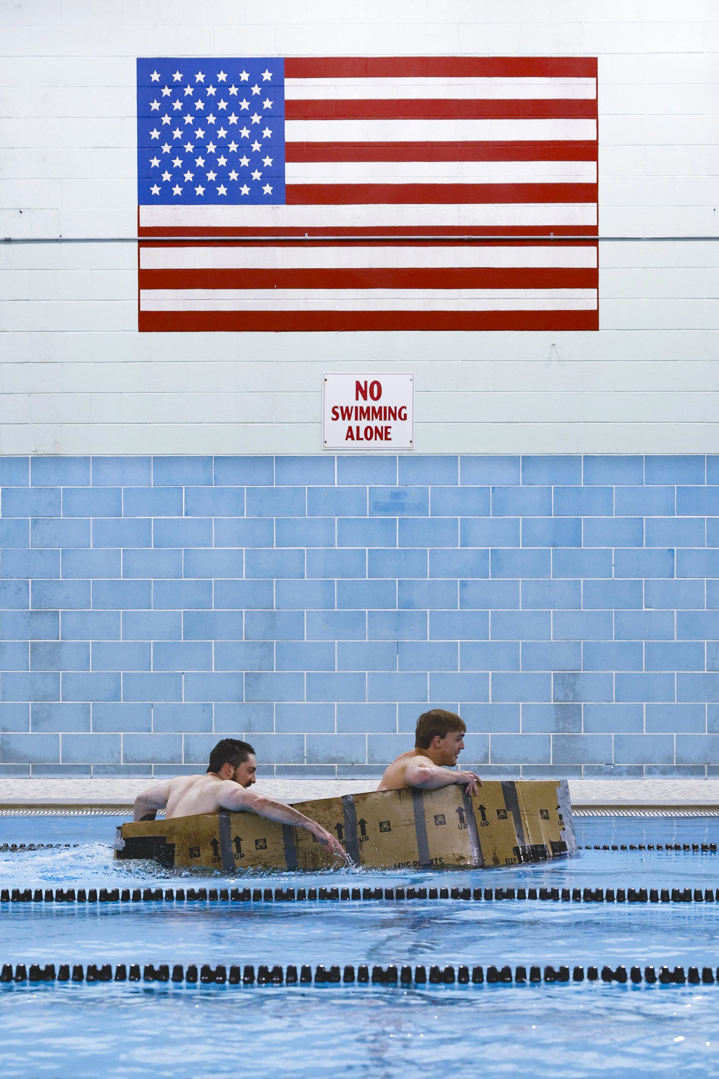  Teammates Daniel Armstrong, left, and Cade Troupe paddle the length of the HPER Complex pool in their cardboard boat on Tuesday, April 30, 2024. 