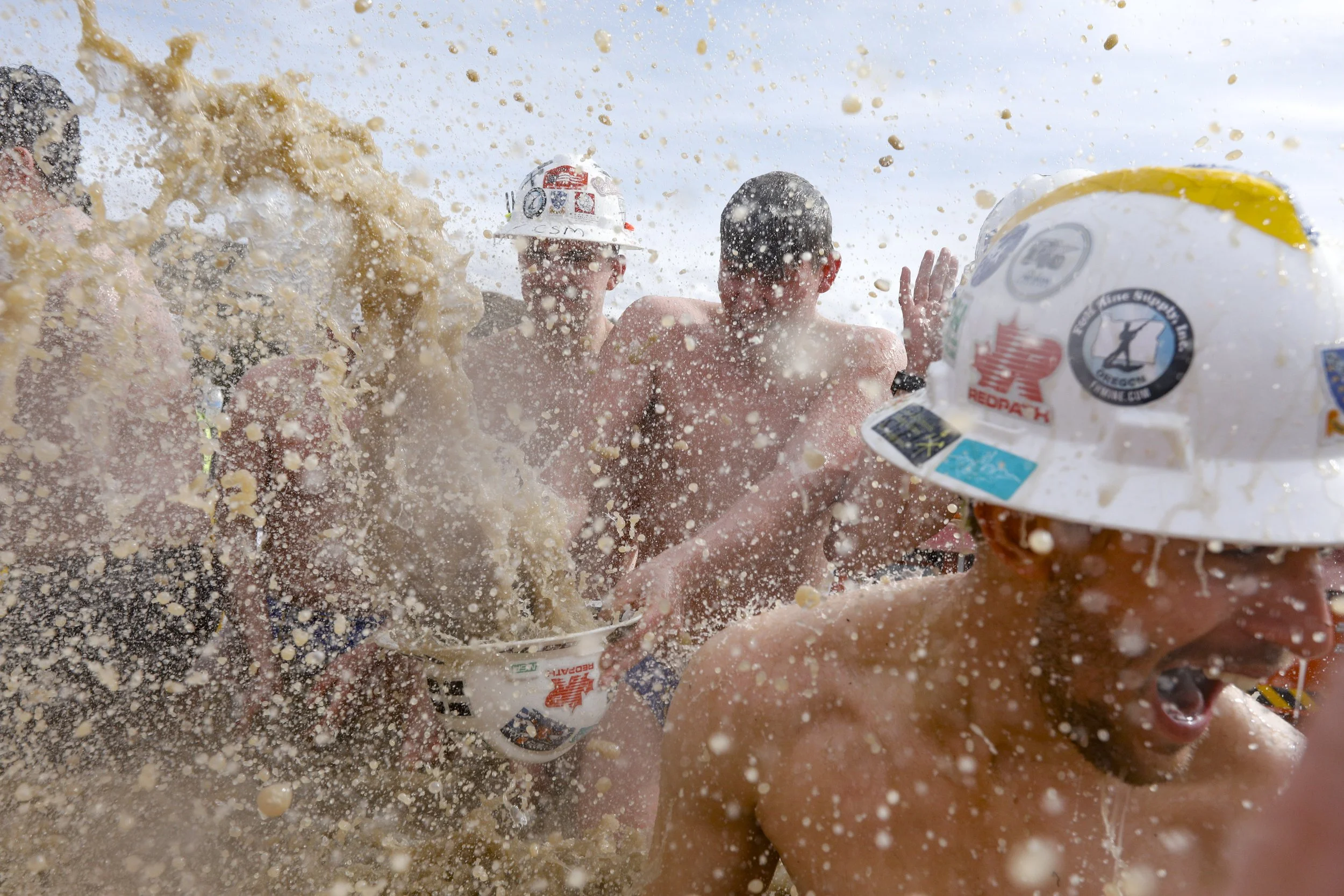  Cambourne School of Mines students Ronan Cosgrove, second from right, and Lewis Andrews celebrate finishing the 46th Annual Intercollegiate Mining Competition by commandeering the large tub of water previously used for the gold pan event on Saturday