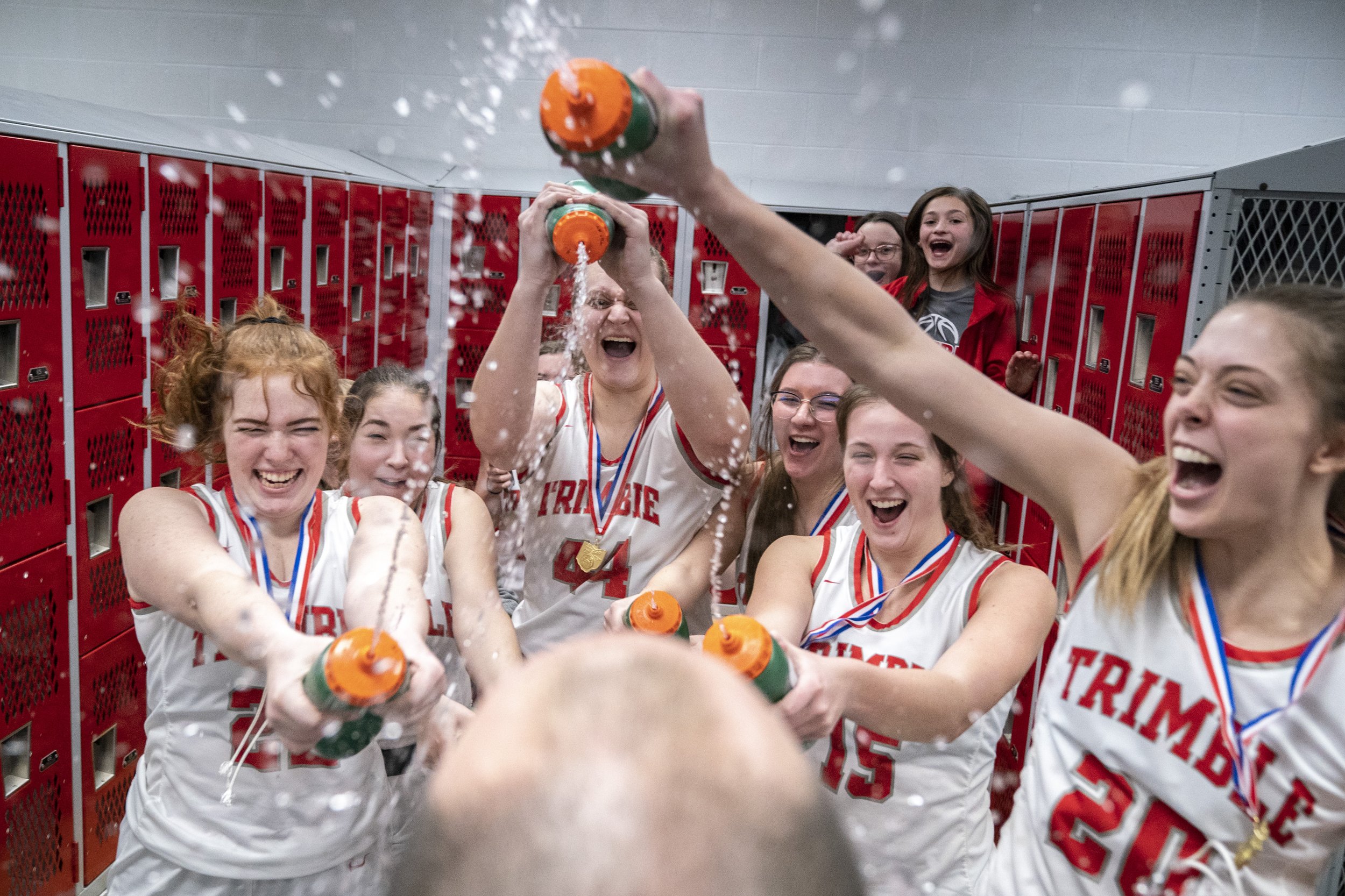  Trimble Lady Cats teammates douse Joe Richards, their head coach, in water after winning the division 4 district finals game for southeast Ohio 62-47 against the South Webster Lady Jeeps, in Piketon, Ohio, on Friday, Feb. 25, 2022. 