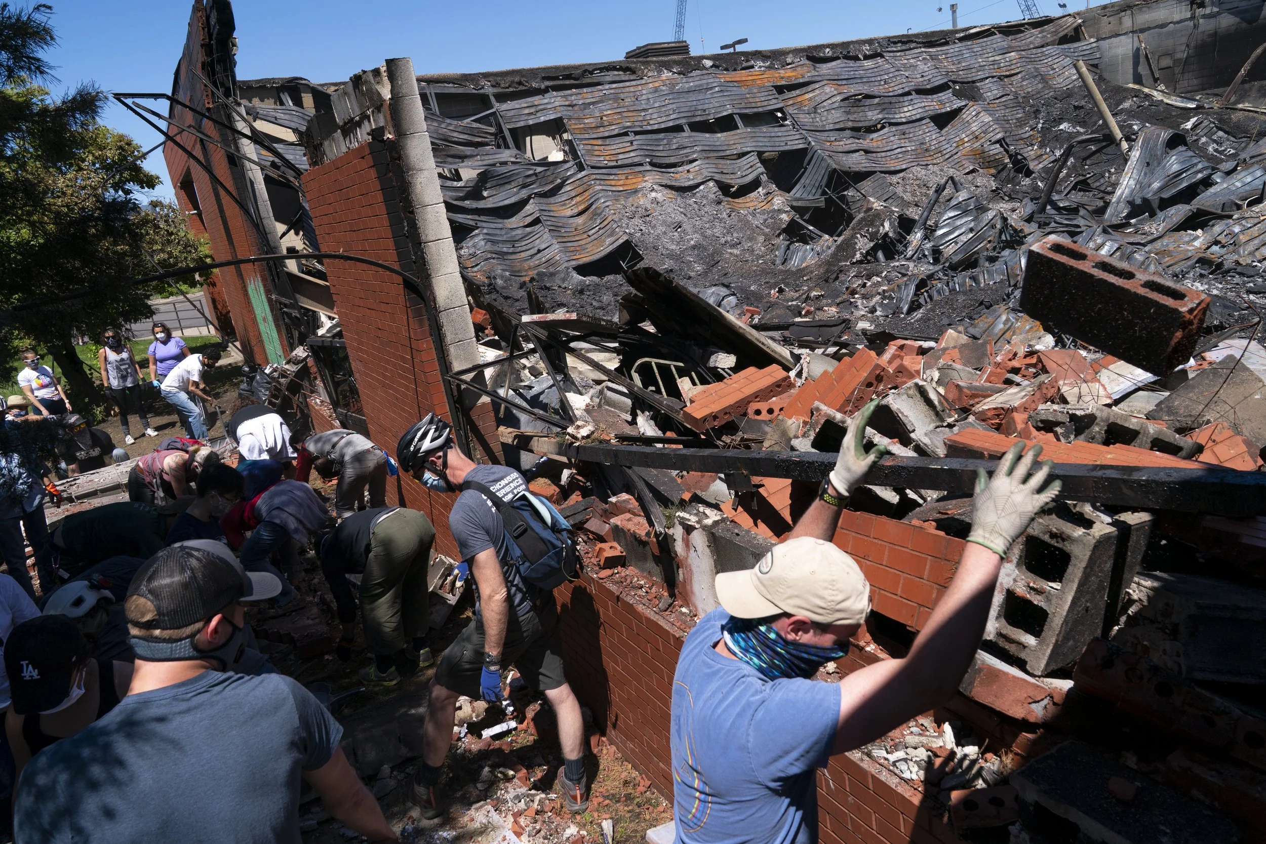  People throw rubble from the Minneapolis U.S. Postal Service building back into the structure after it was burned down following another day of protests after George Floyd was murdered while in Minneapolis Police Department custody on May 30, 2020. 