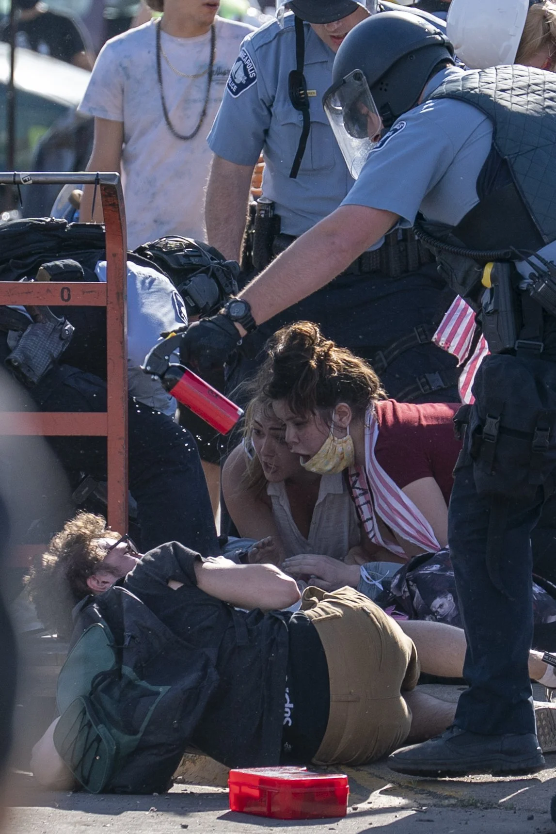  A Minneapolis Police Department officer points a can of mace at a protester as the situation escalates outside of the looted Target on Lake Street in Minneapolis on May 28, 2020. 