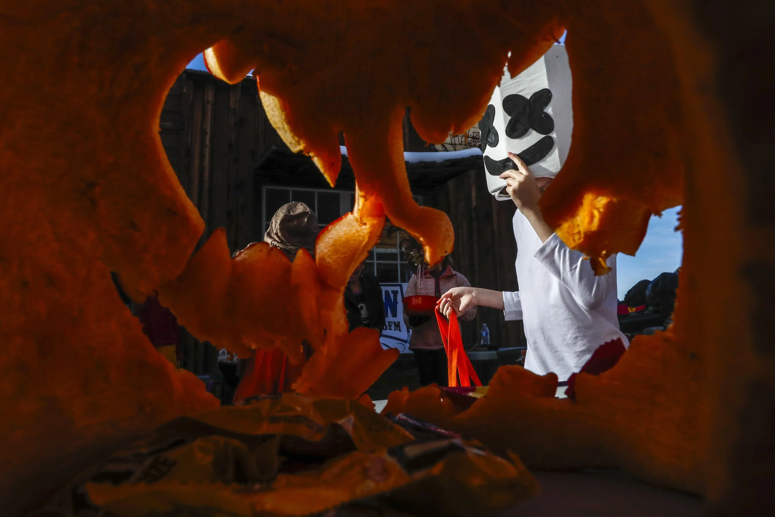  Deagyn Pratt, 12, is seen from the inside of a carved pumpkin while trick-or-treating dressed up as the artist Marshmello during the Halloween inspired Treat Street event at the World Museum of Mining on Tuesday, Oct. 31, 2023 in Butte. 