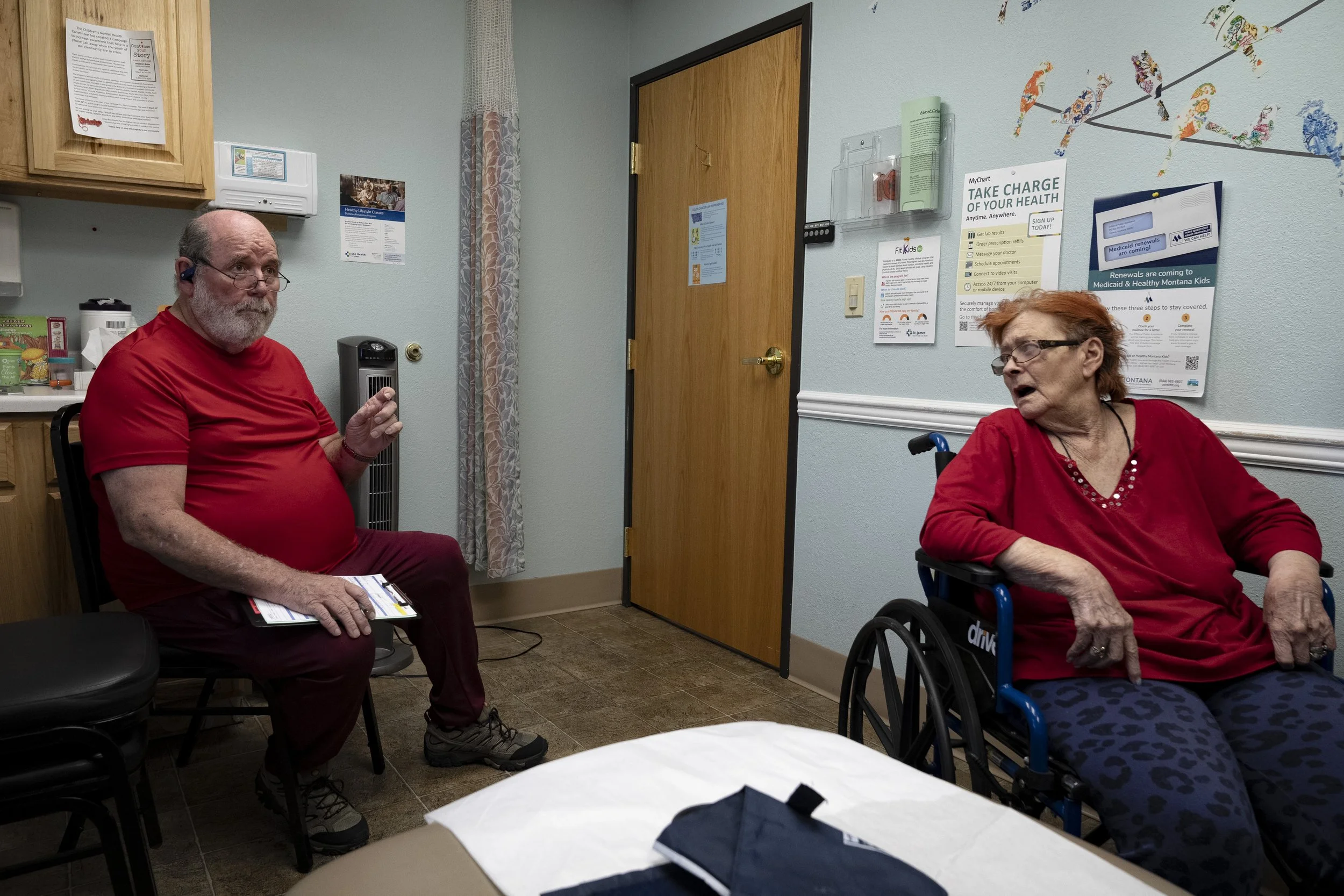  During a medical appointment, Lynne looks over at Wayne as he speaks to Dr. Serena Brewer. Lynne had difficulty understanding others when they would speak to her, but she would understand when Wayne repeated their words back to her. Wayne was her me