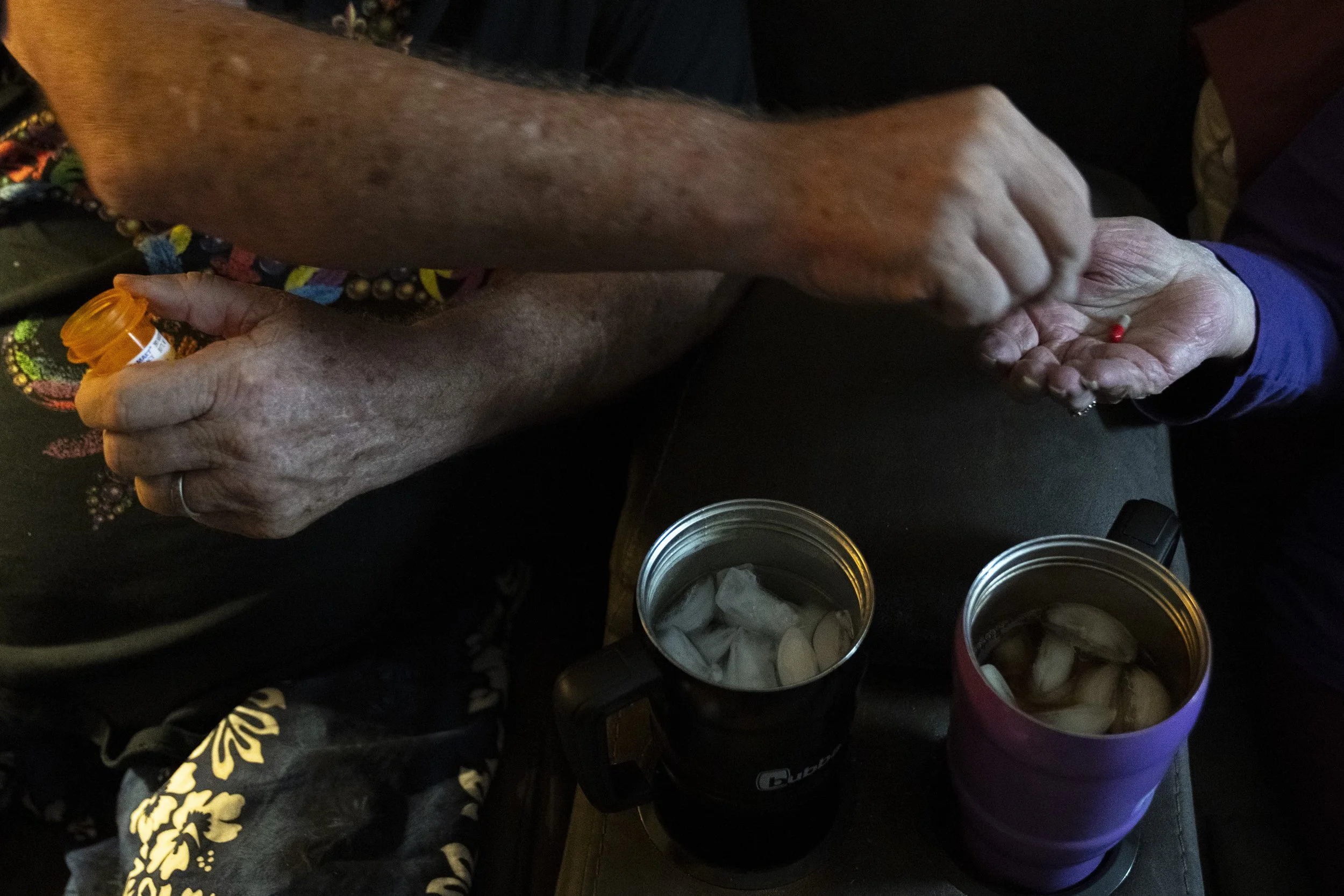  Wayne reaches over to give Lynne her medication. As dementia progressed, Lynne’s ability to manage her own day-to-day activity decreased. 