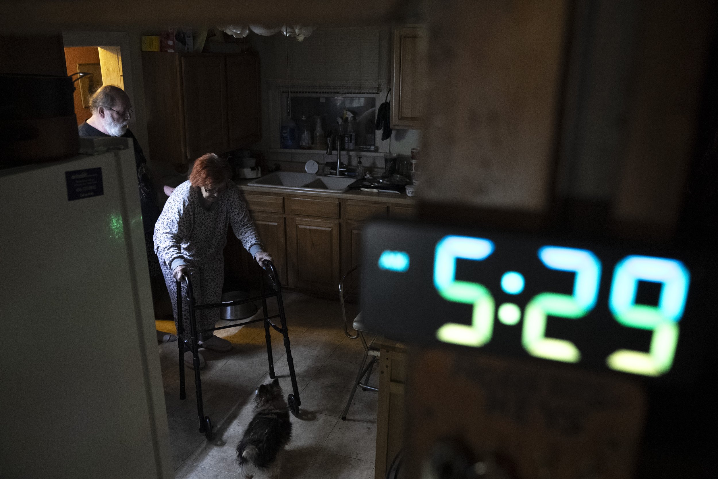  Lynne makes her way through the kitchen back to her recliner after using the bathroom early one Wednesday morning. Wayne began following her to ensure her safety, regardless of the time of day, as she started to fall and injure herself. 