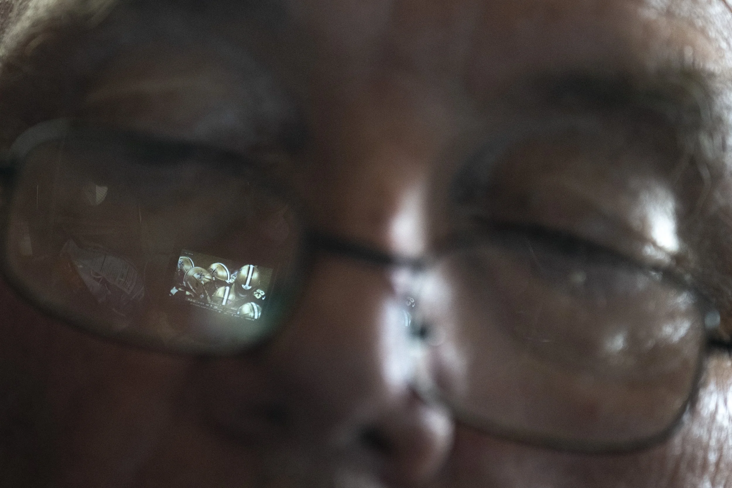  The New Orleans Saints and Tennessee Titans NFL football game is reflected in Wayne’s glasses as he watches while relaxing next to Lynne. Wayne used to attend local football games with friends, but he has abstained from this pastime since Lynne was 