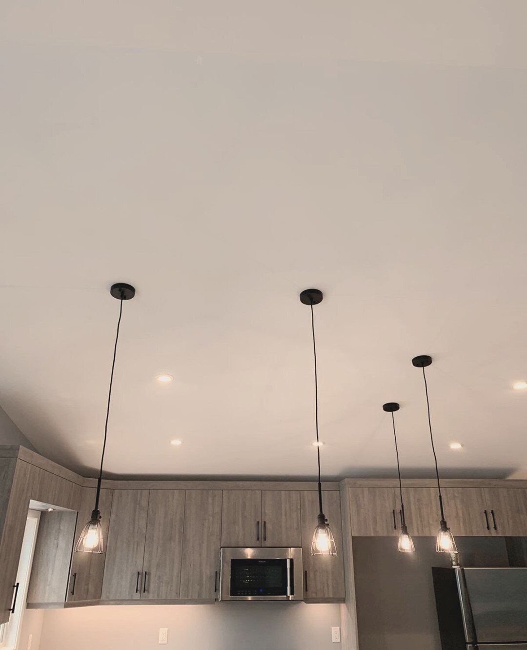 Love a well lit kitchen? Crossline loves it too! Check out these snazzy ceiling potlights, delicate pendants, and undercabinet lighting. #lighting