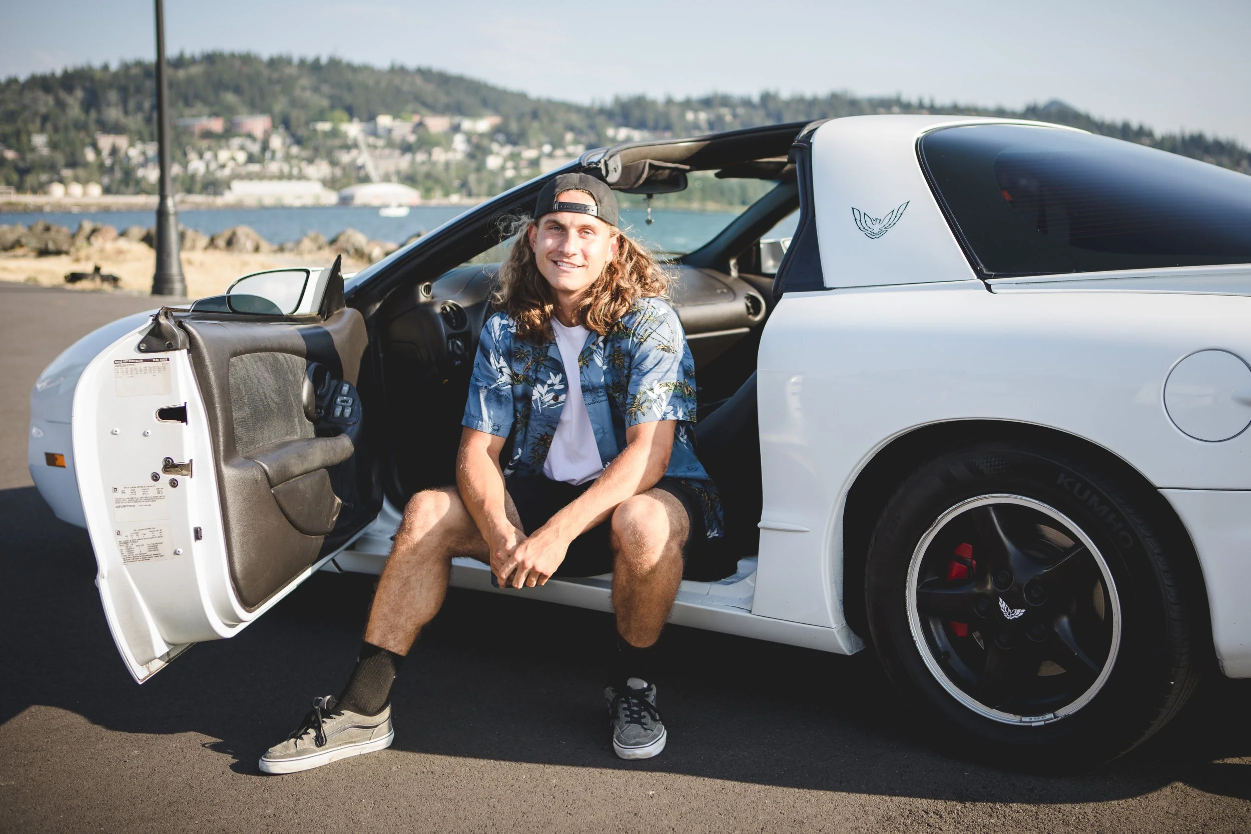 Senior portrait of guy with car at Zuanich Park in Bellingham, Wa