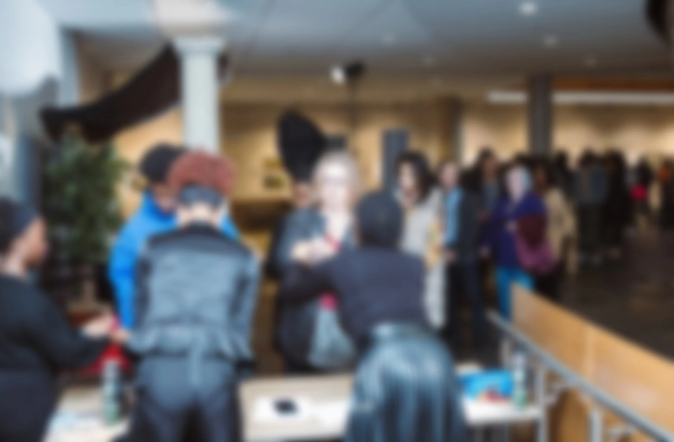 Blurred photo of audience members lined up to attend the event.