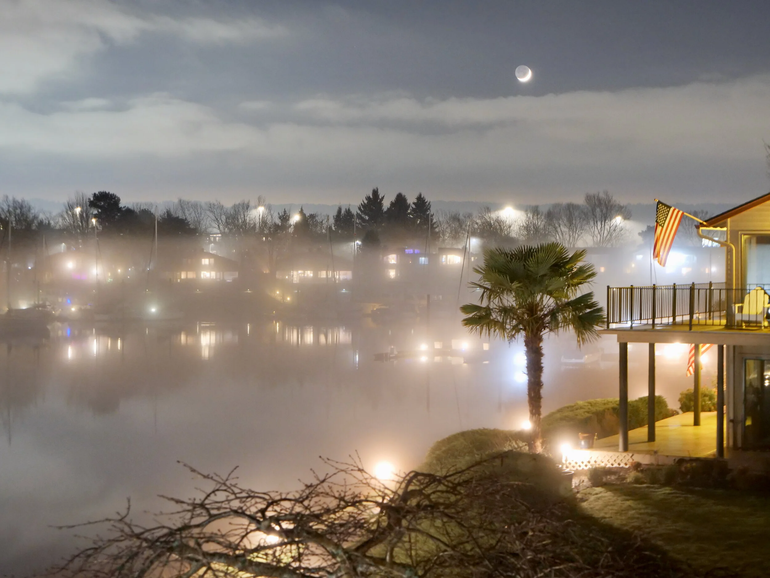 Hayden Bay near Portland Oregon, lights on the bay and sliver of a moon