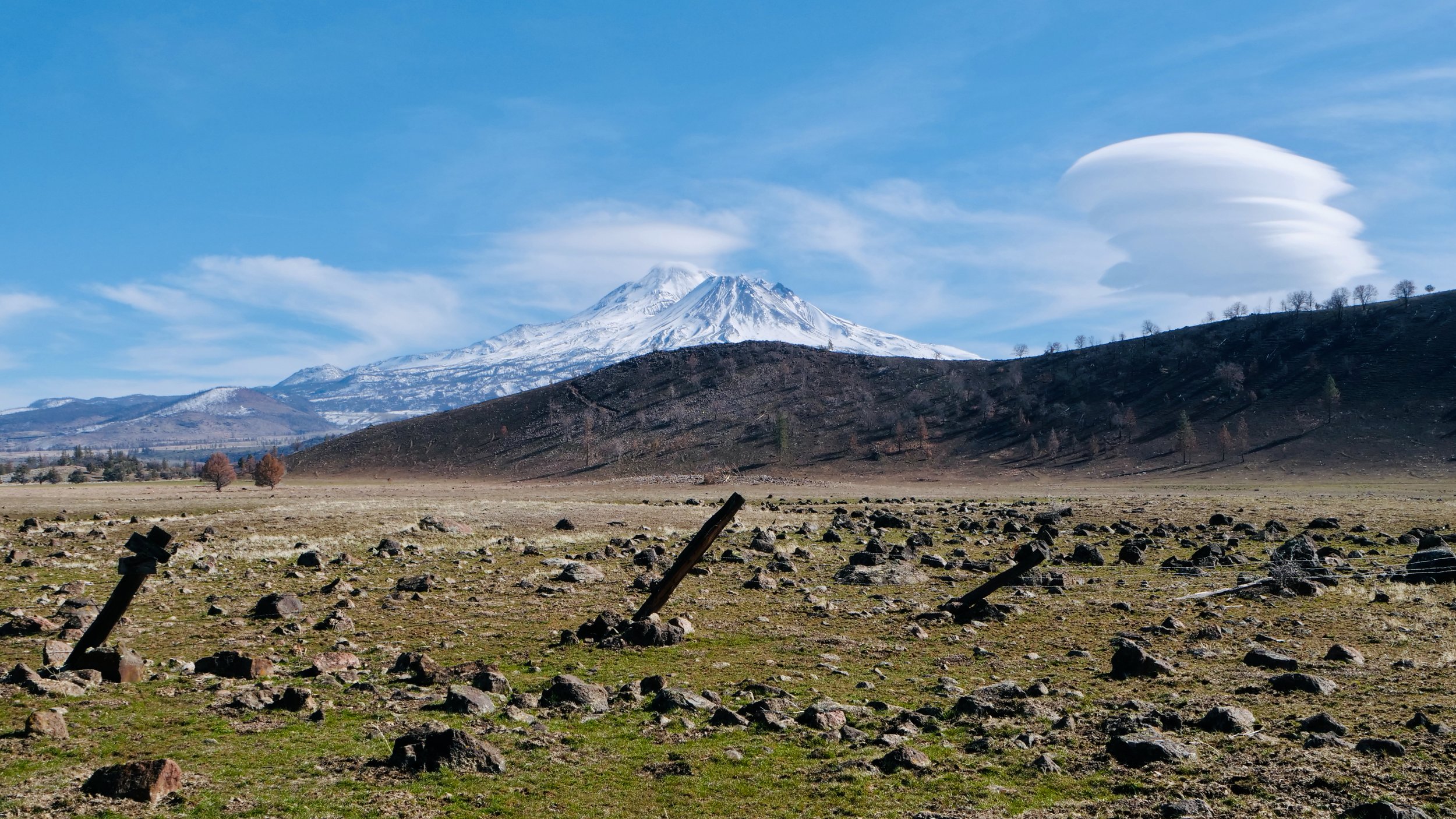 Mt Shasta in California, beautiful cloud formations and rustic scene 16X9