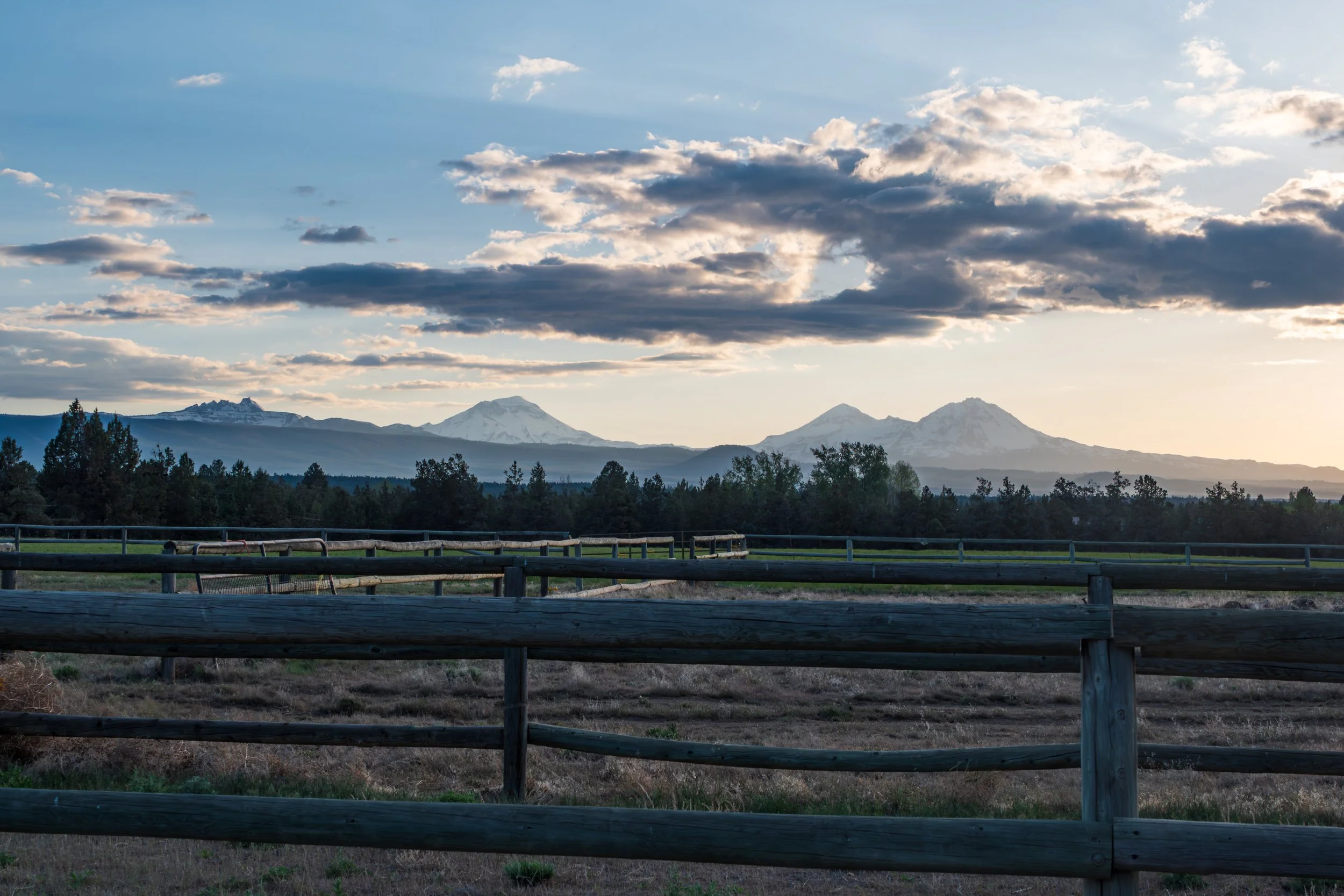 Wooden Fence Framing the Three Sisters Mountains at Sunset in Central Oregon