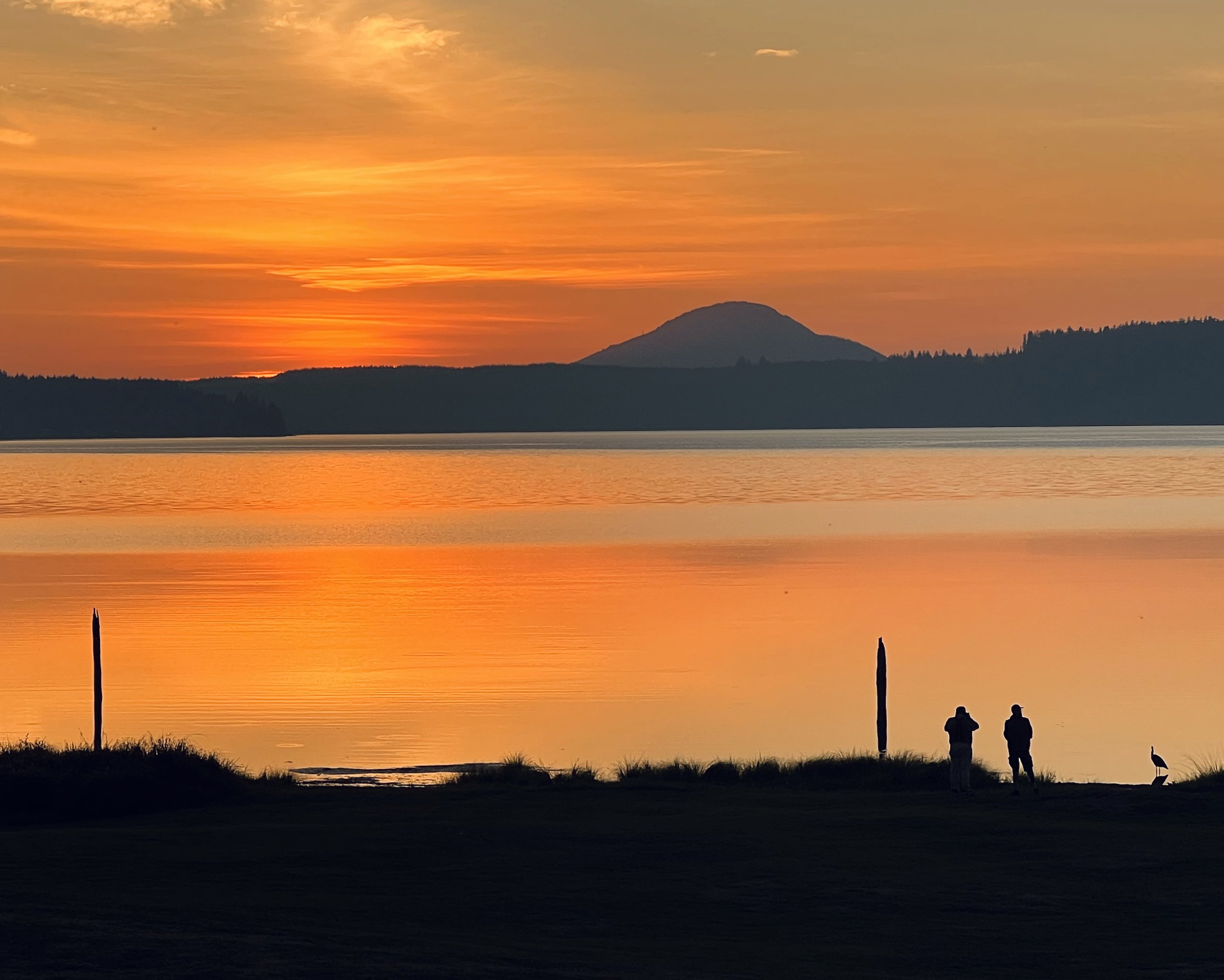 Lake Quinault at Sunset with silhouette of people near the shore