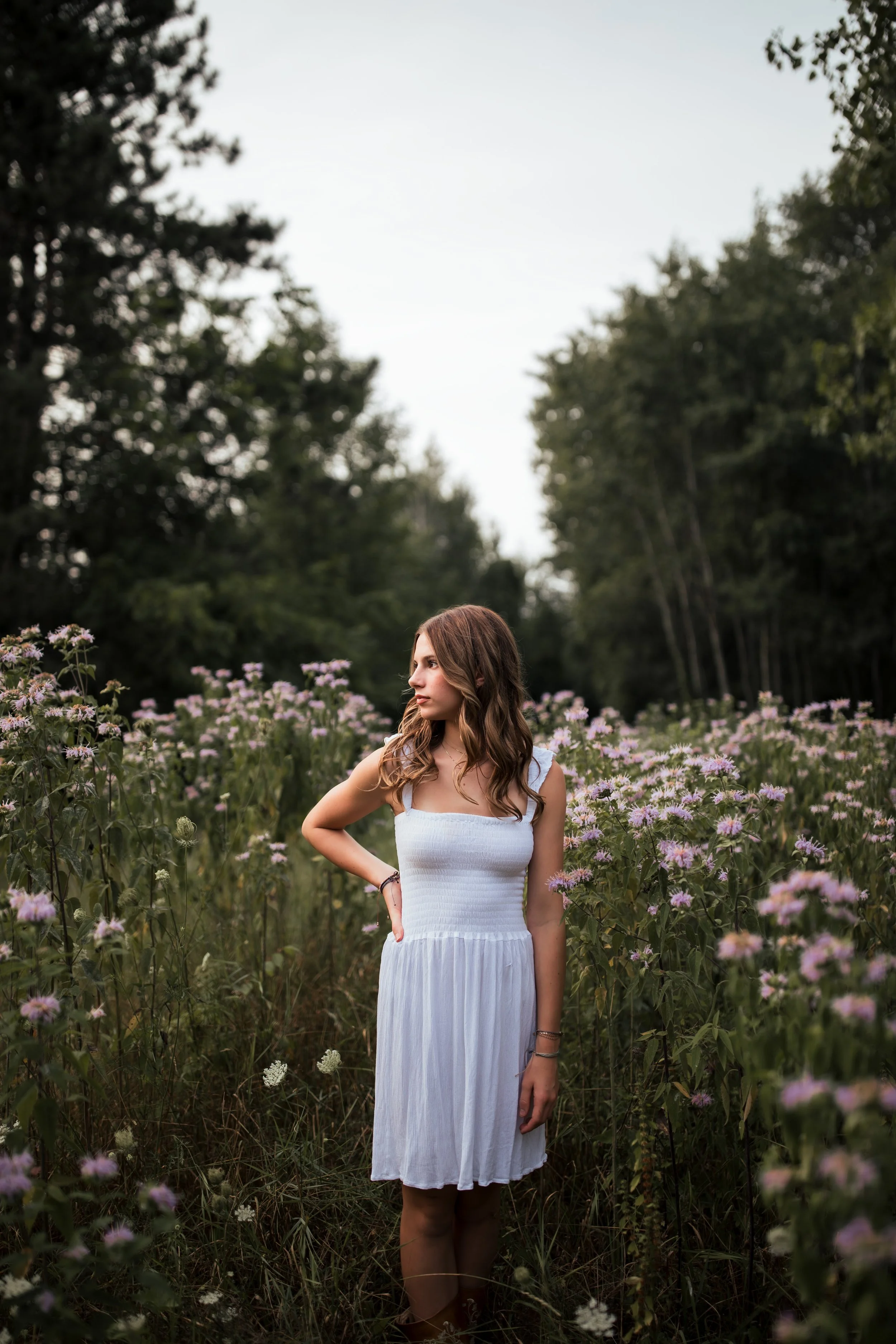 Outdoor senior portrait photos in a purple flower field in Western, NY