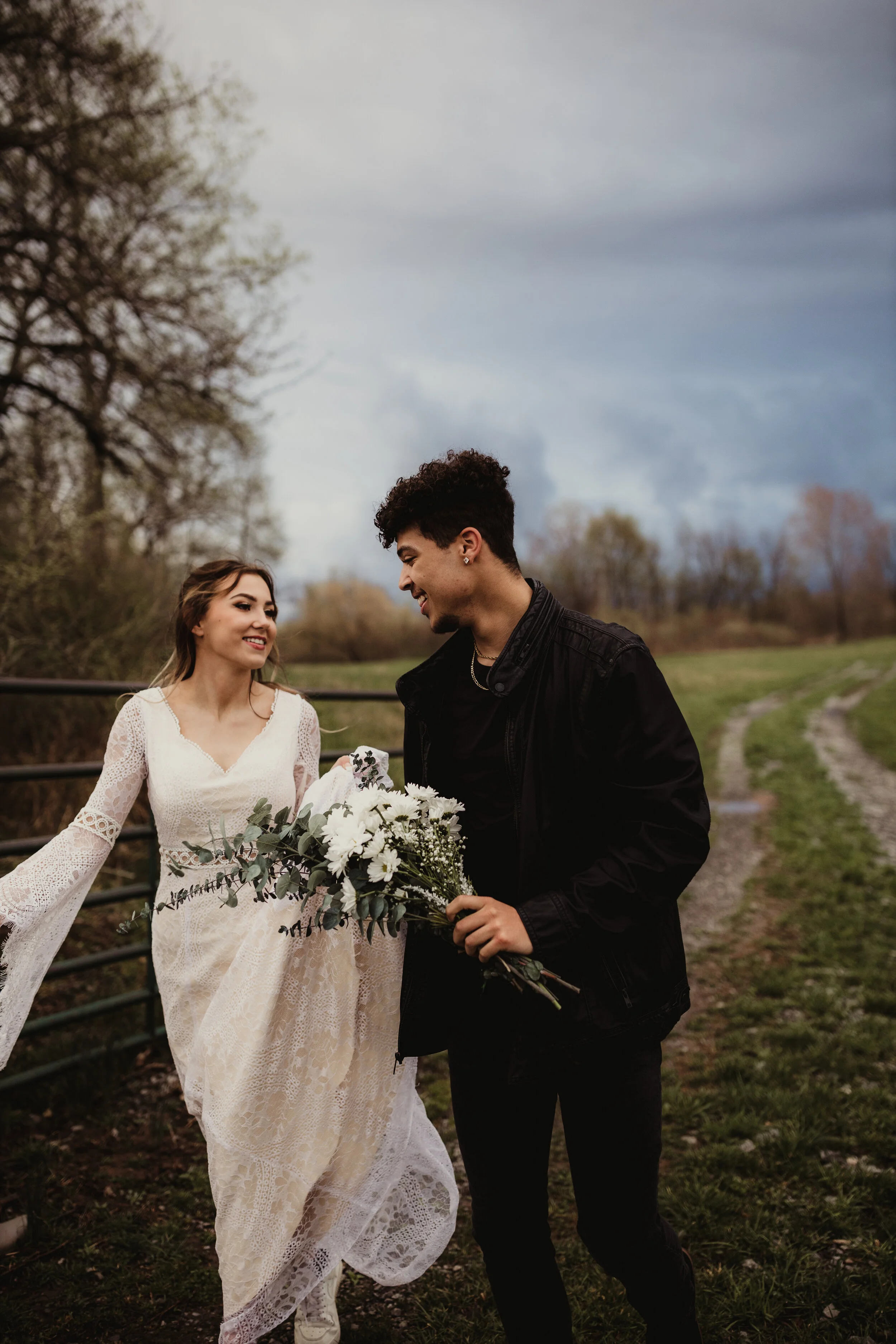 Playful couples elopement photography session running around a trail in the woods