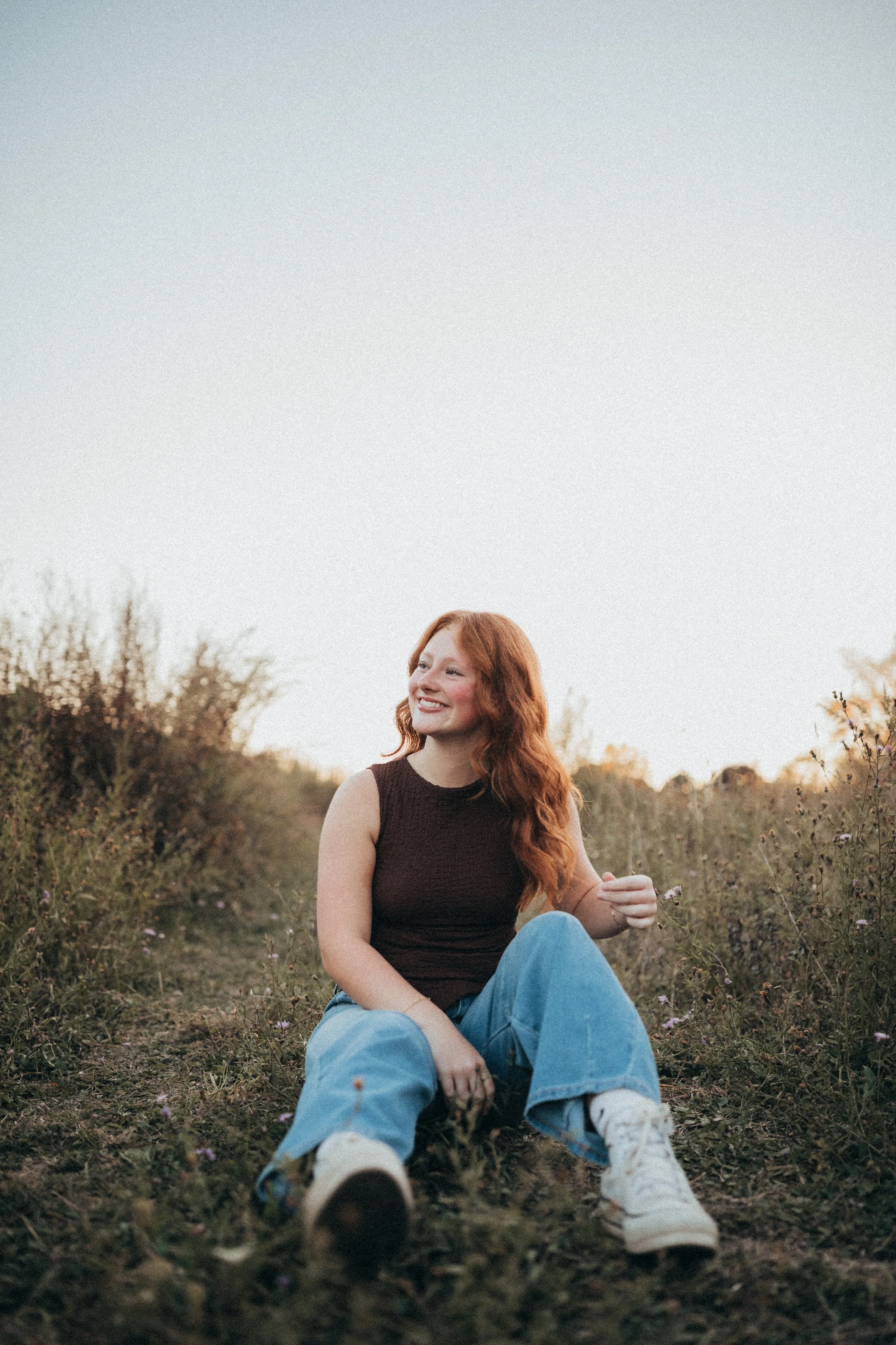 Candid portrait in a grassy field during golden hour in Western NY