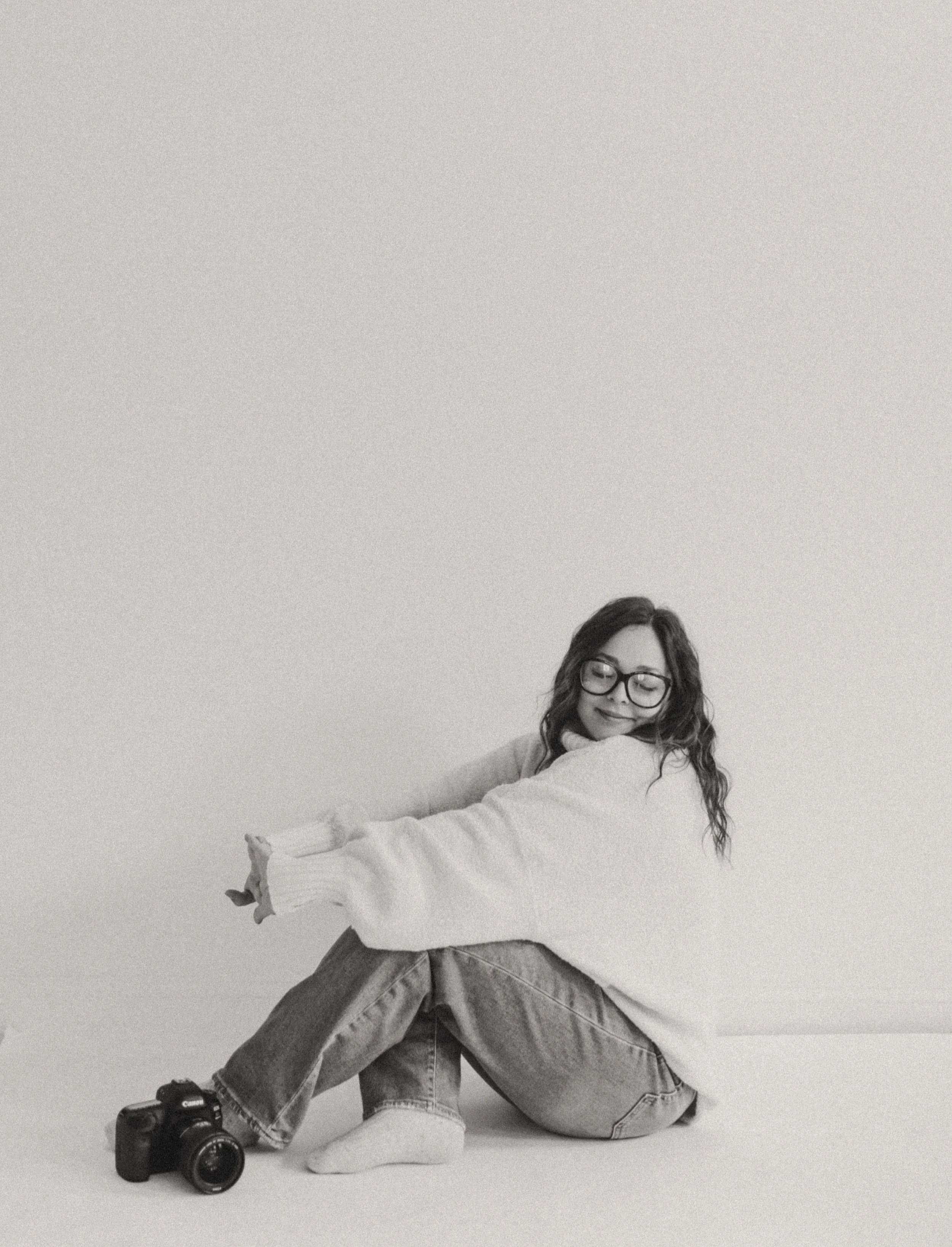 Lifestyle portrait and travel photographer sitting in studio with camera in western, NY