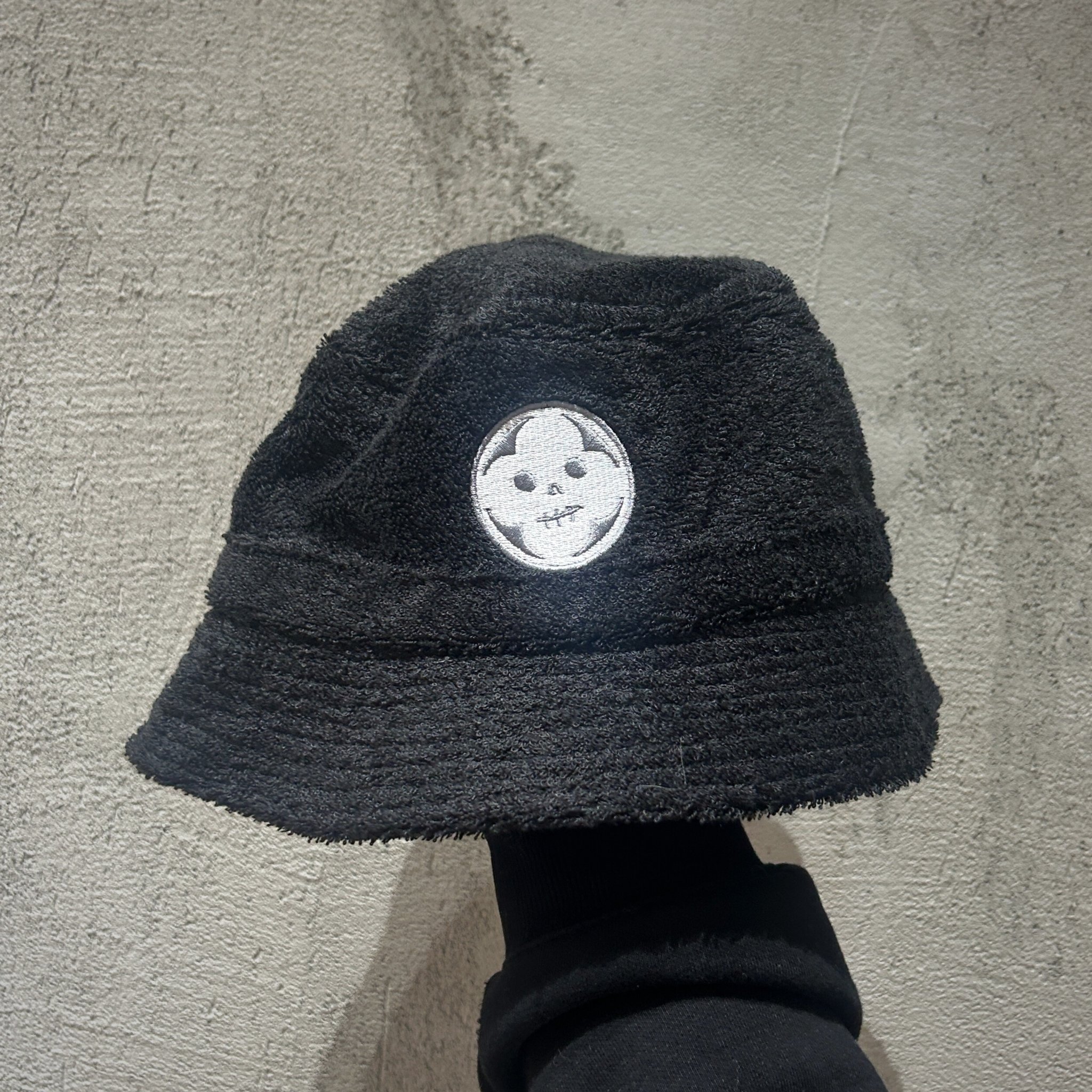 Black Terry Hat from Absolution studios merch store featuring the shops logo embroided on the front