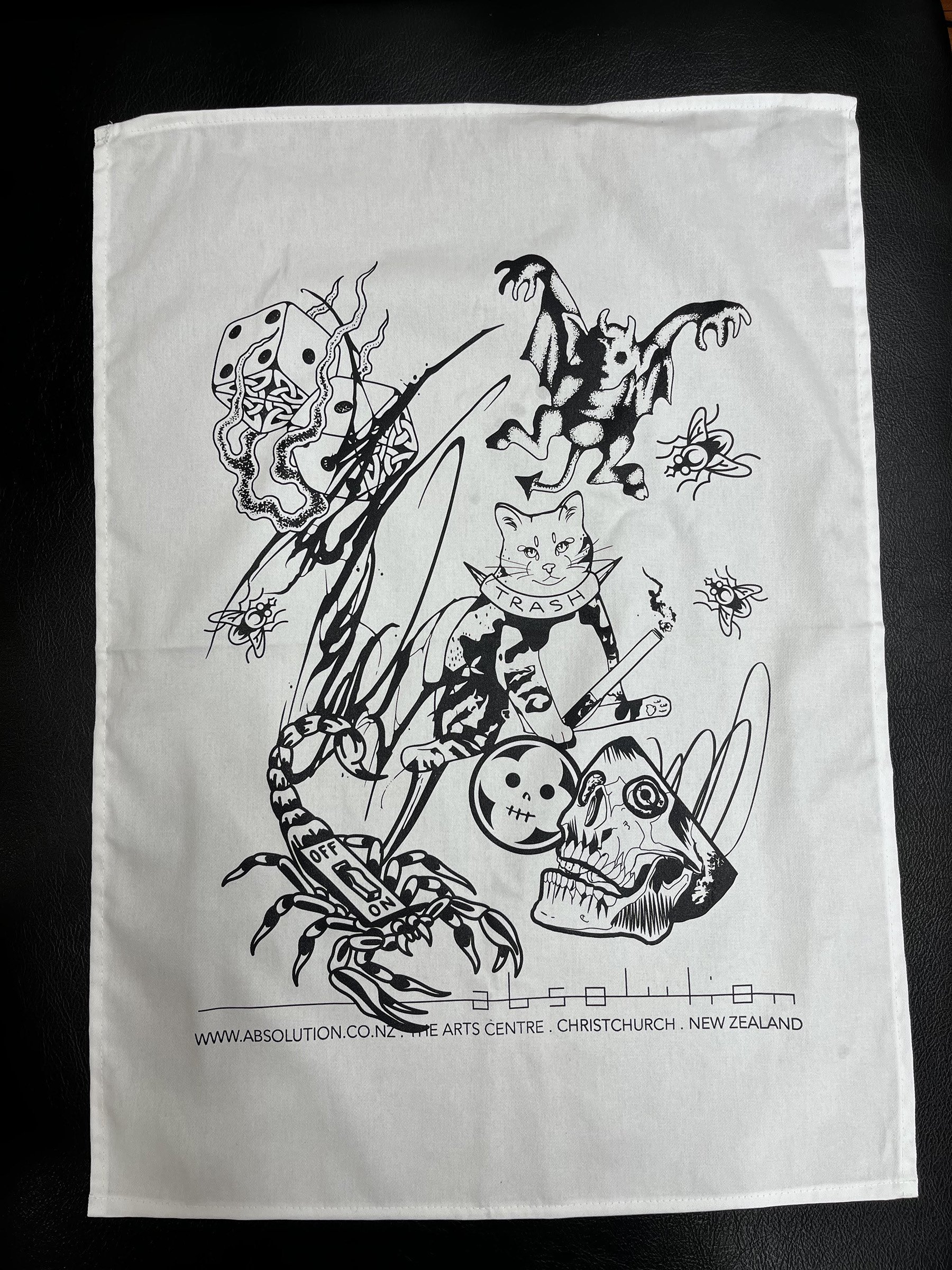 Flat lay of Absolution Tattoo Studio tea towel – white 100% cotton with black single-colour screen print featuring flash-style artwork by resident Christchurch tattoo artists.