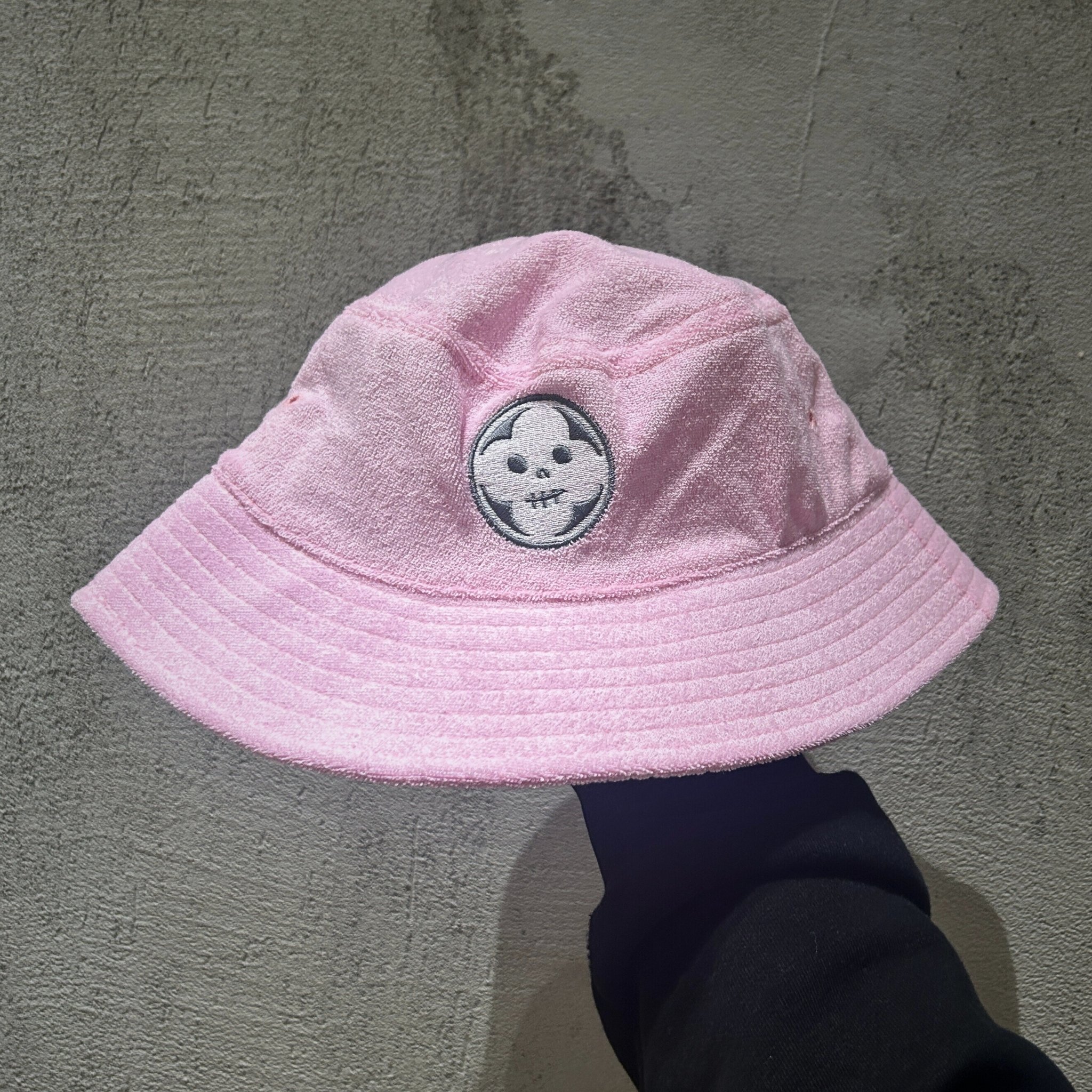 Held up image of Absolution limited edition pink terry hat in size XL