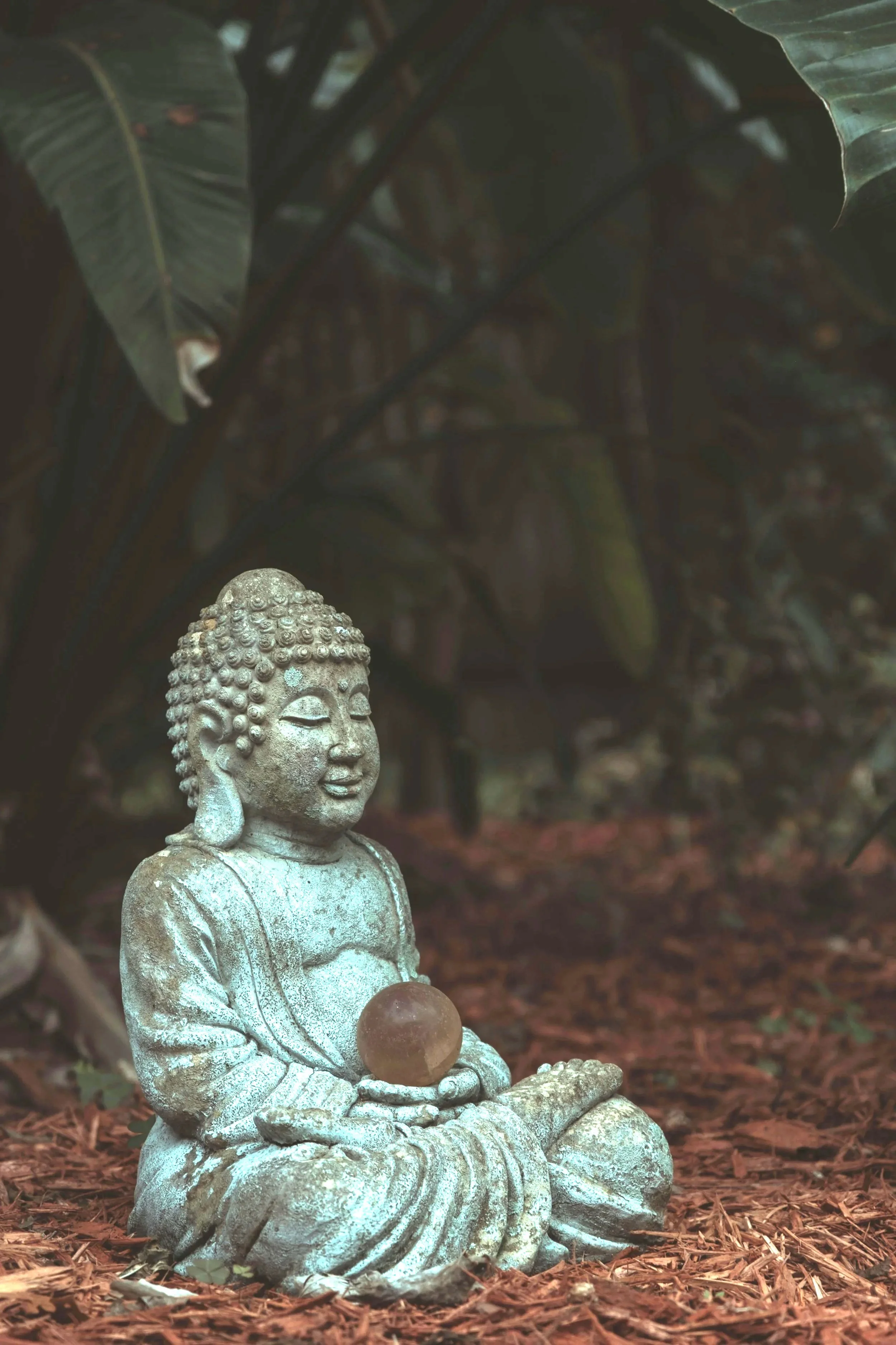 Meditative statue seated in the forest creating a calm and reflective atmosphere