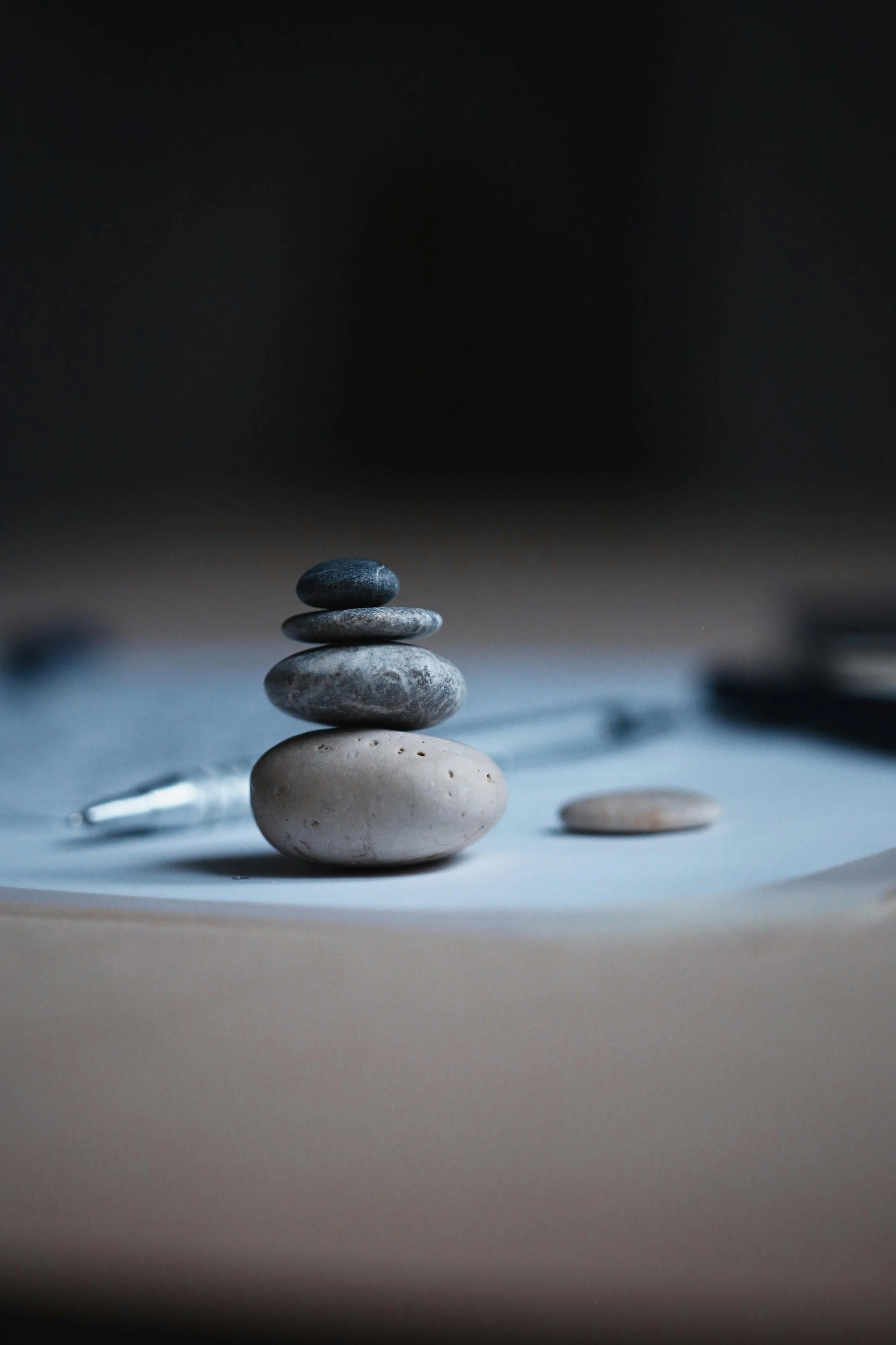 Stepping stones on a desk with paper and pen, representing reflection and thoughtful practice