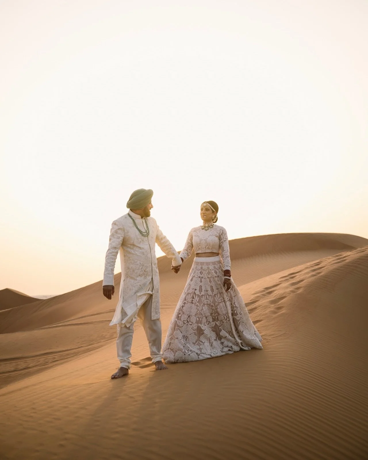 Raj &amp; Kiran, just married - and just them - wrapped in golden silence and desert breeze.

After the sacred beauty of their Anand Karaj, we stepped into the stillness of the Dubai desert. The noise faded, the pace slowed, and it was just two heart