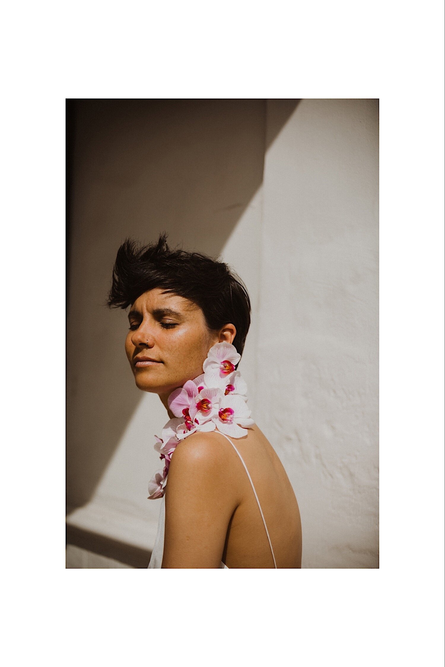 15_TWS-64_orchids_beauty_white_alternative_elope_alt_inspo_ideas_rock_haircut_flowers_jumpsuit_bridal_summer_photography_orchid_pink_inspiration_no_bouquet_Gender-neutral_wedding_Androgynous_bride_photographer_necklace_creative_florals.jpg