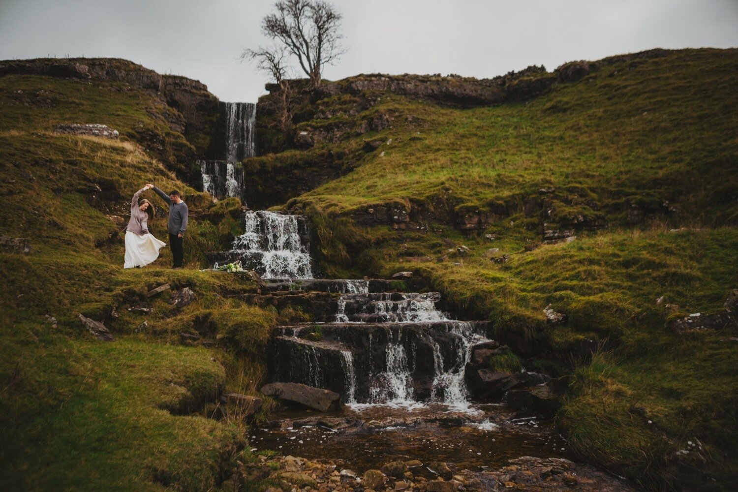 34_TWS-137__grey_dramatic_landscape_alternative_elope_alt_rock_blue_waterfall_winter_flowers_offbeat_dales_waterfalls_autumn_elopement_photography_ribbons_moody_bride_silver_wedding_yorkshire_rainy_cloudy_cosy_weather_photographer_florals_groom.jpg